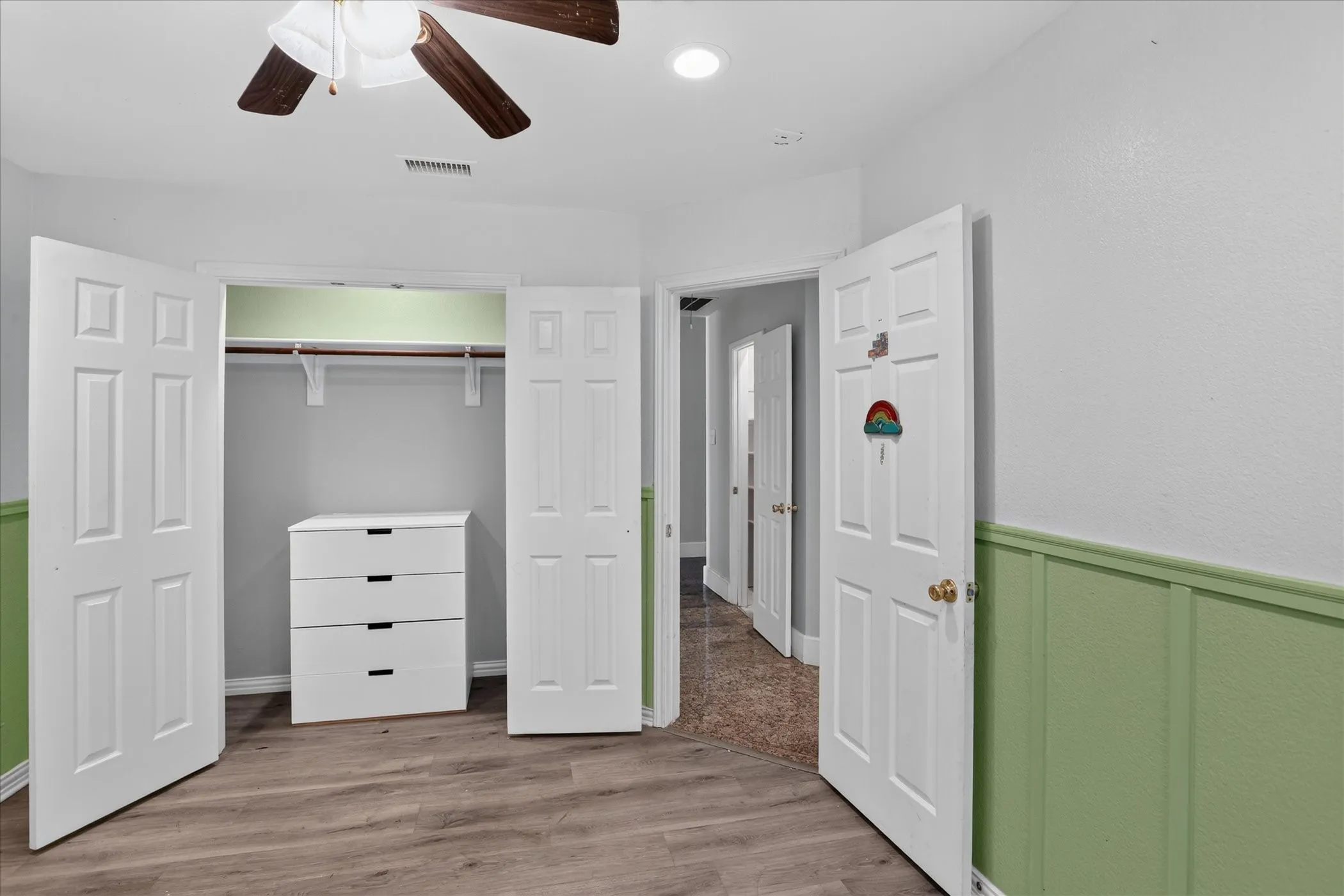 Wood-finish flooring with a ceiling fan light fixture