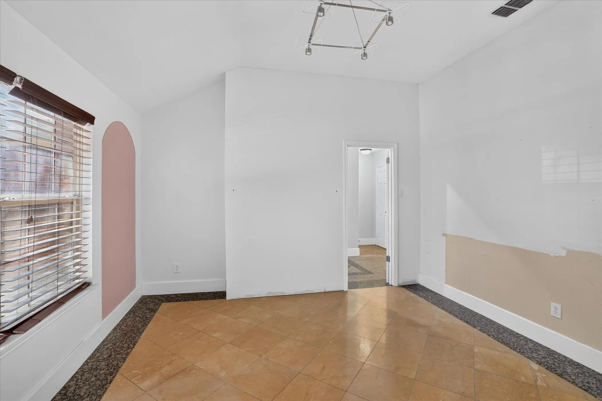 Vaulted ceilings and recessed lighting illuminate an open space