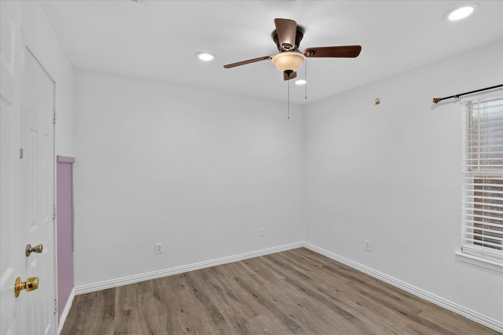 Wood-finish flooring, recessed lighting, and a ceiling fan with integrated light fixture