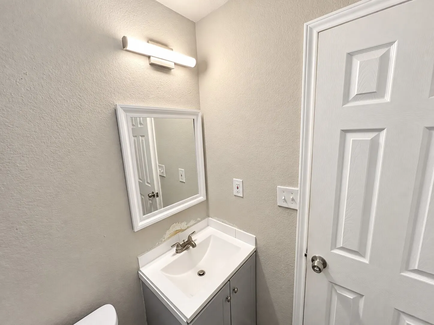 Recessed vanity with integrated sink and brushed nickel faucet