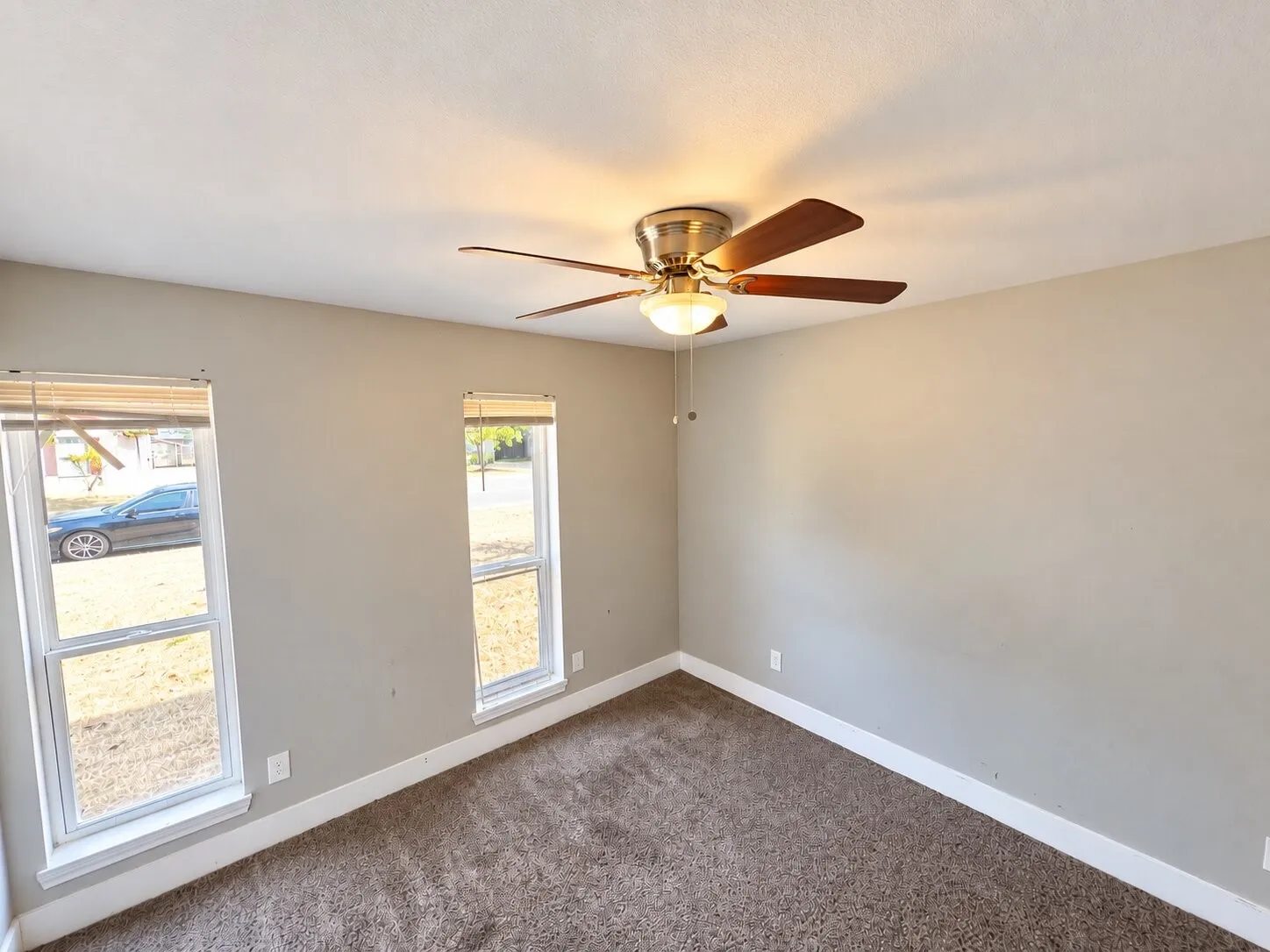 Recessed lighting, ceiling fan with light fixture, two windows, wall-to-wall carpeting, and light-toned walls
