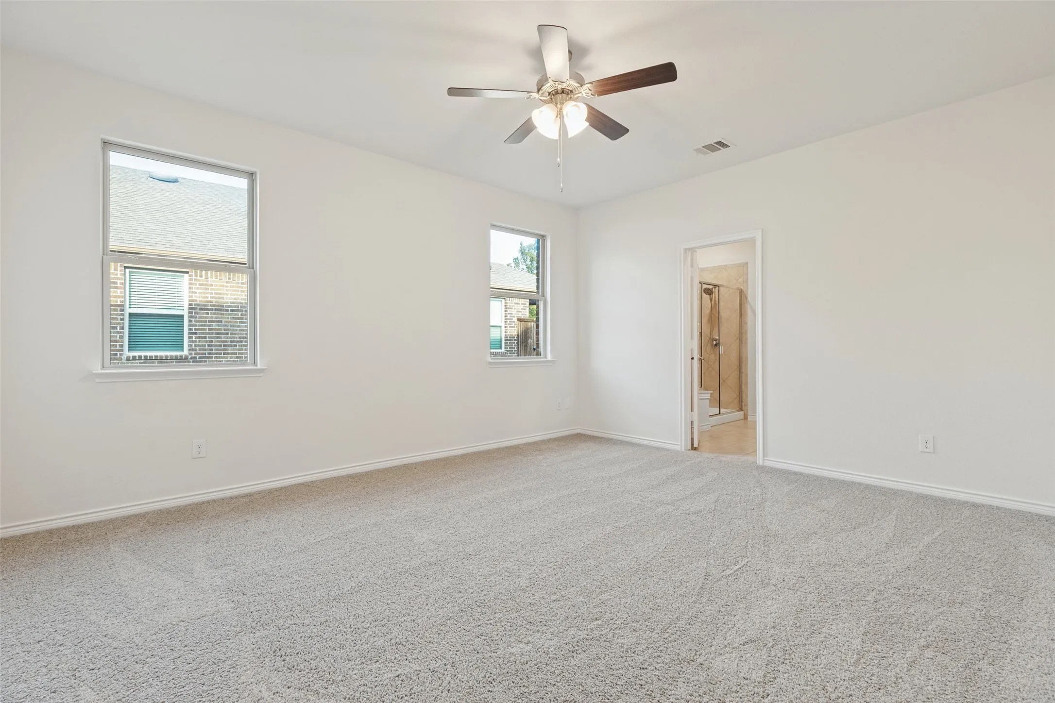 Neutral wall finishes, recessed lighting, and a ceiling fan with integrated lighting