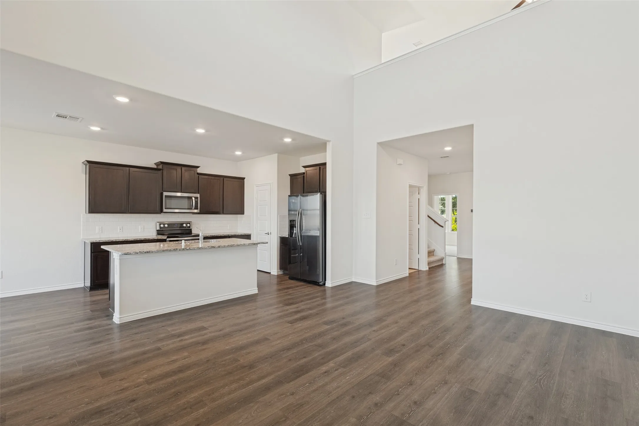 Open-concept living space with wood-finish flooring