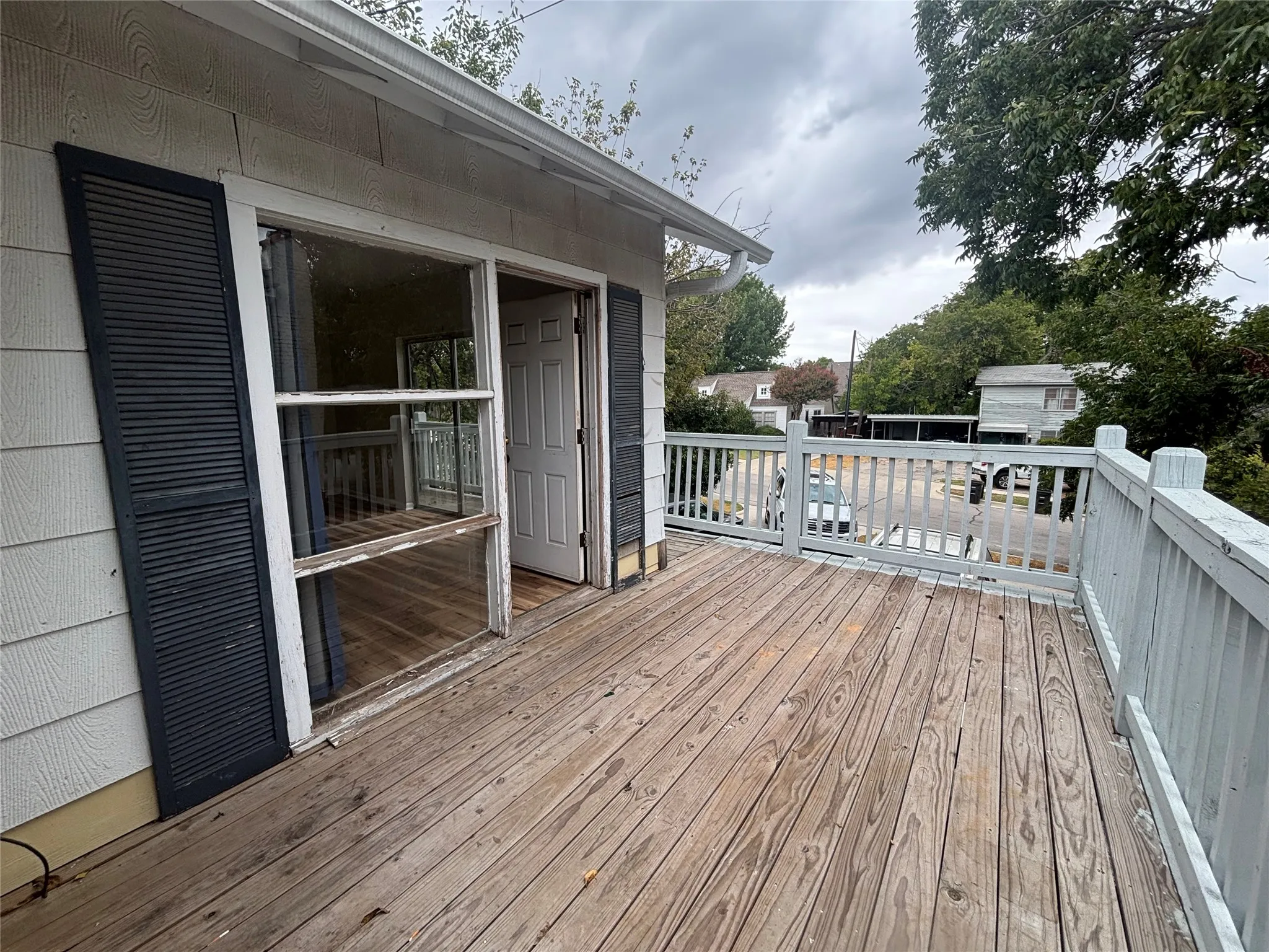 Exterior deck featuring wood flooring and a painted wood railing