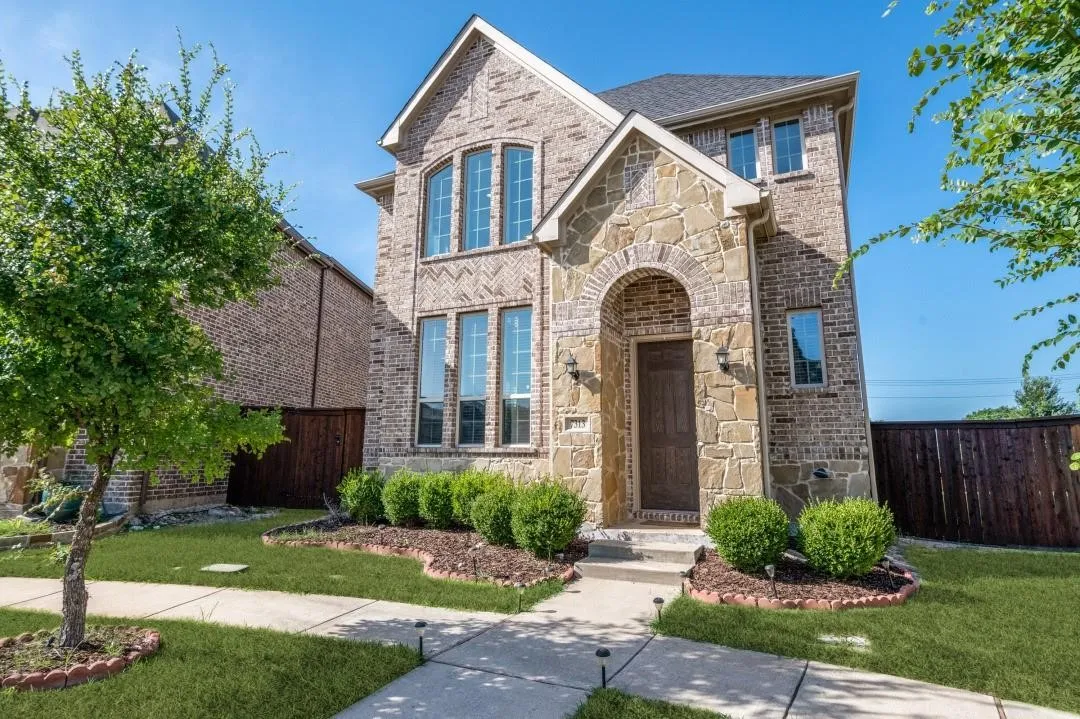 Brick and stone exterior with an arched entryway