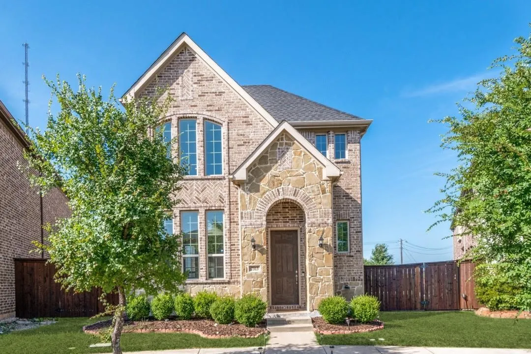 Brick and stone veneer exterior with arched entry