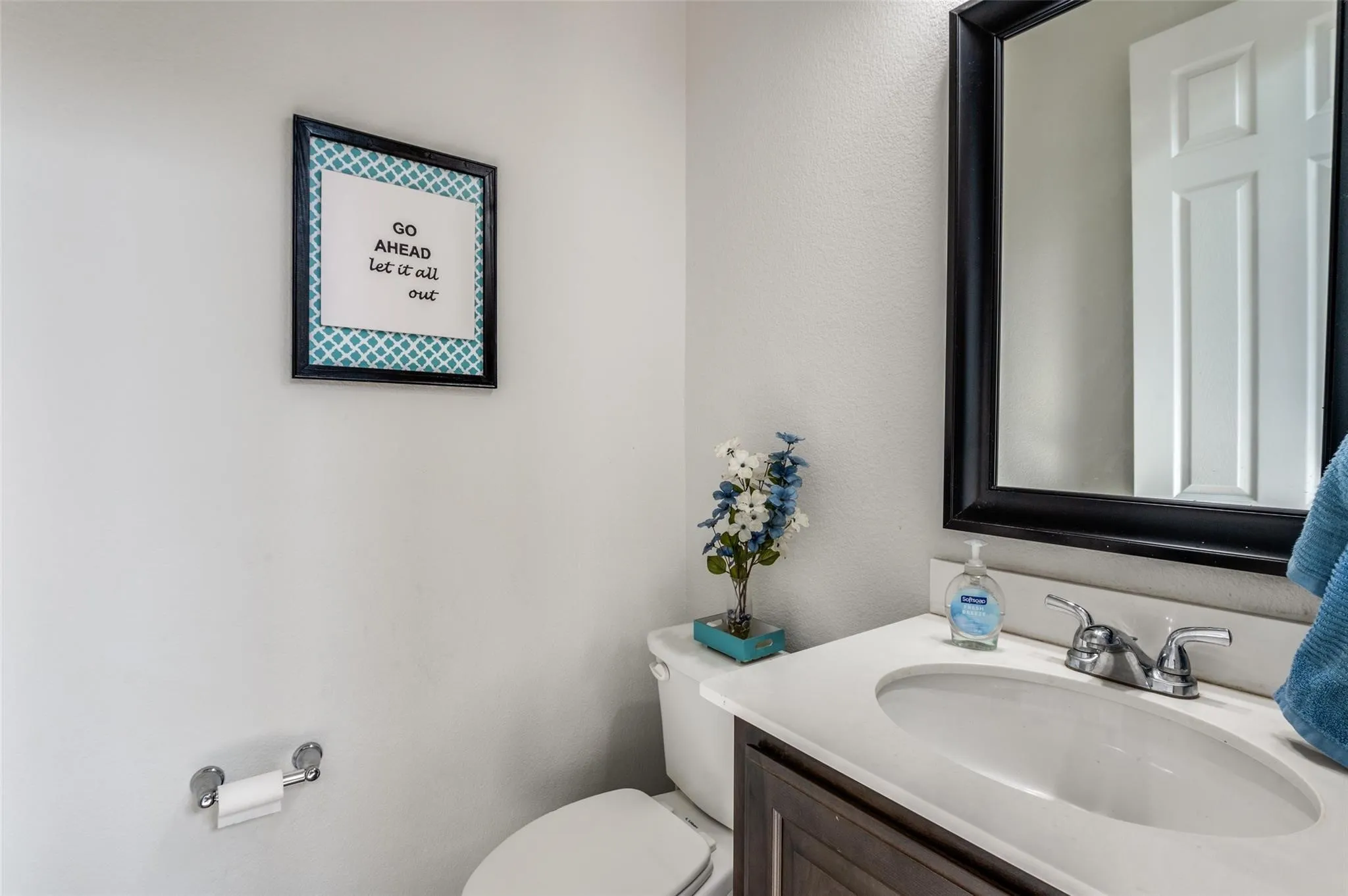 Built-in vanity with a single basin sink, chrome faucet, and integrated countertop