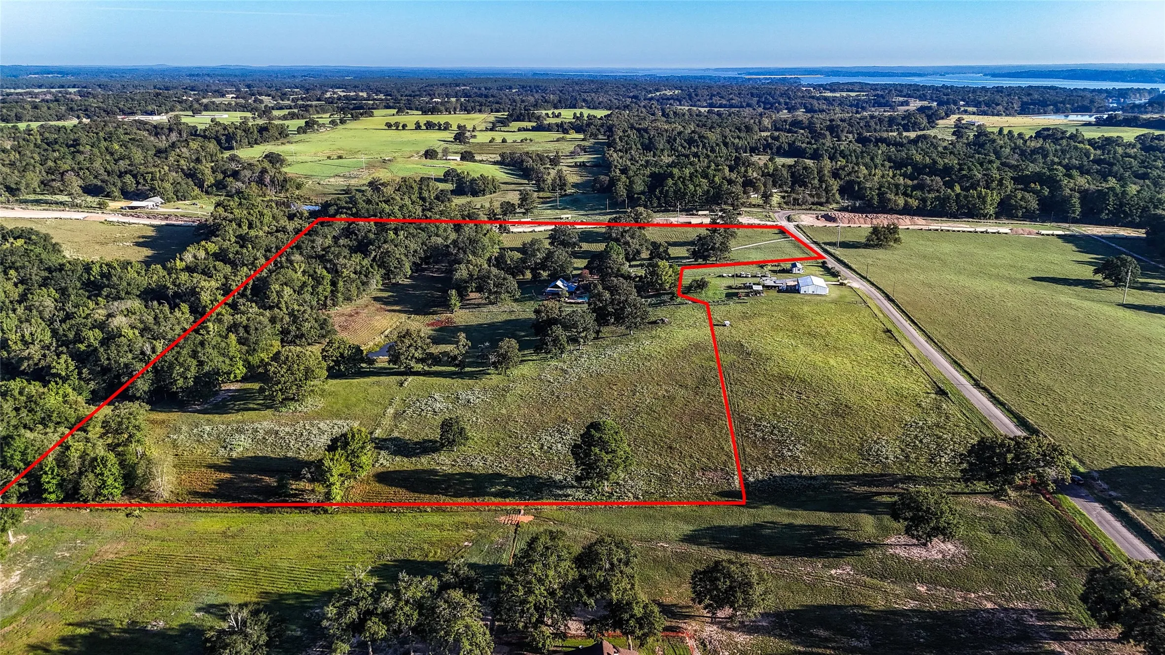 Expansive acreage featuring a mix of cleared land and mature trees