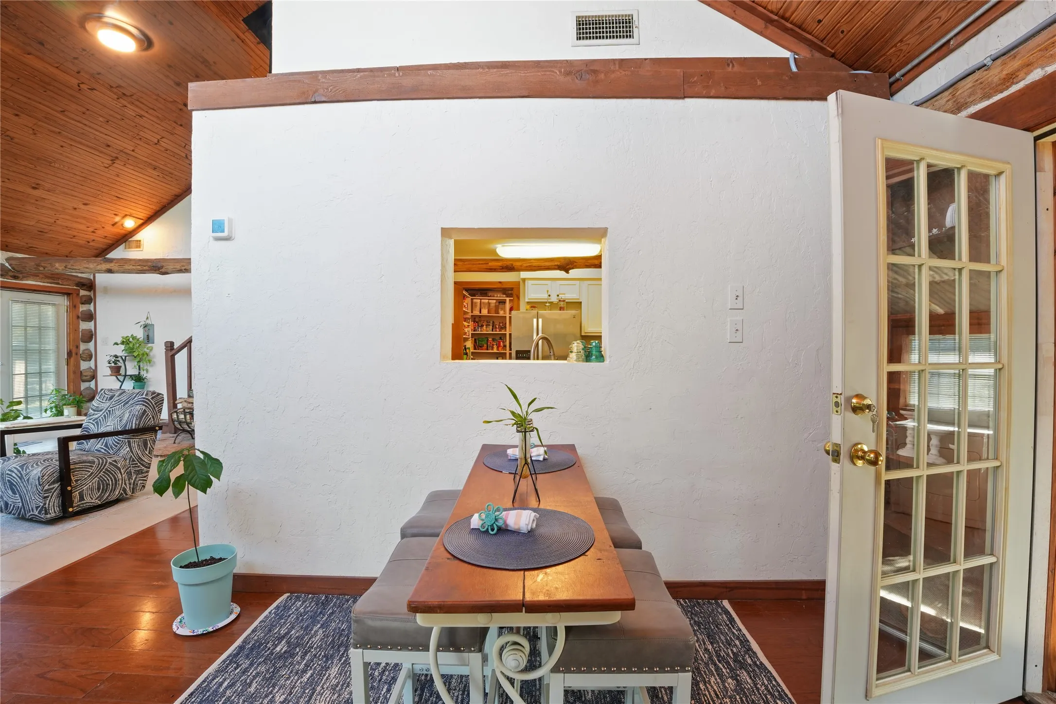 Wood-finish flooring with exposed wood beams and ceiling panels