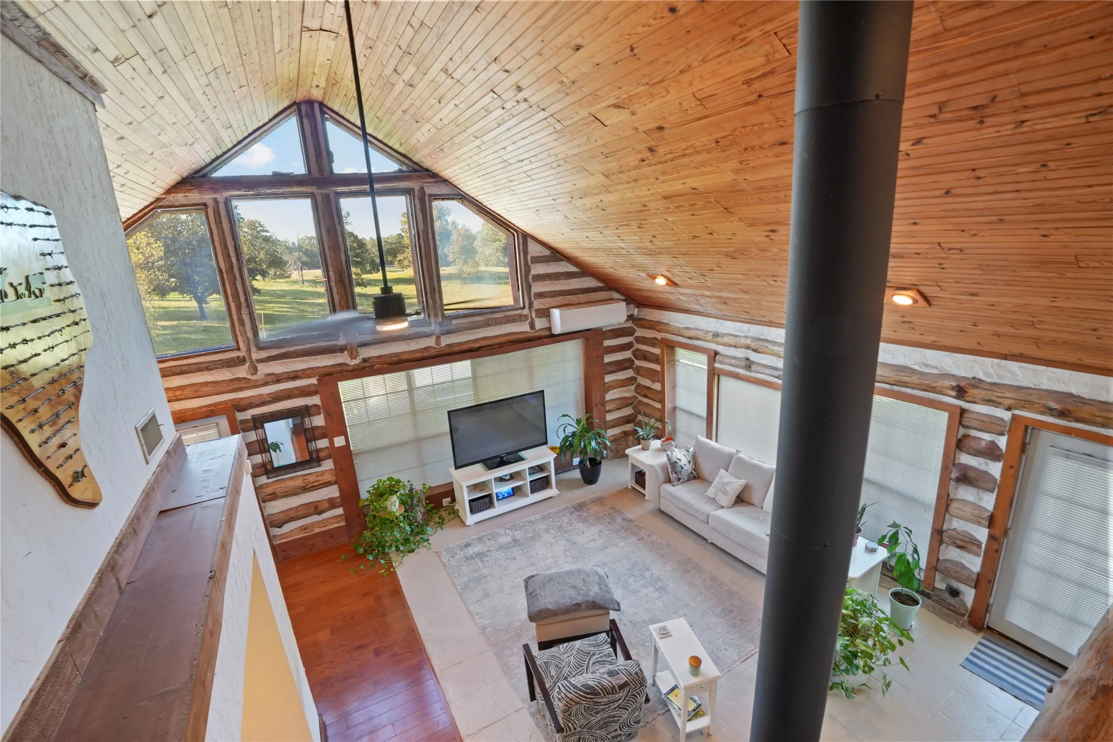 Vaulted wood-paneled ceilings, exposed log walls, and wood-finish flooring