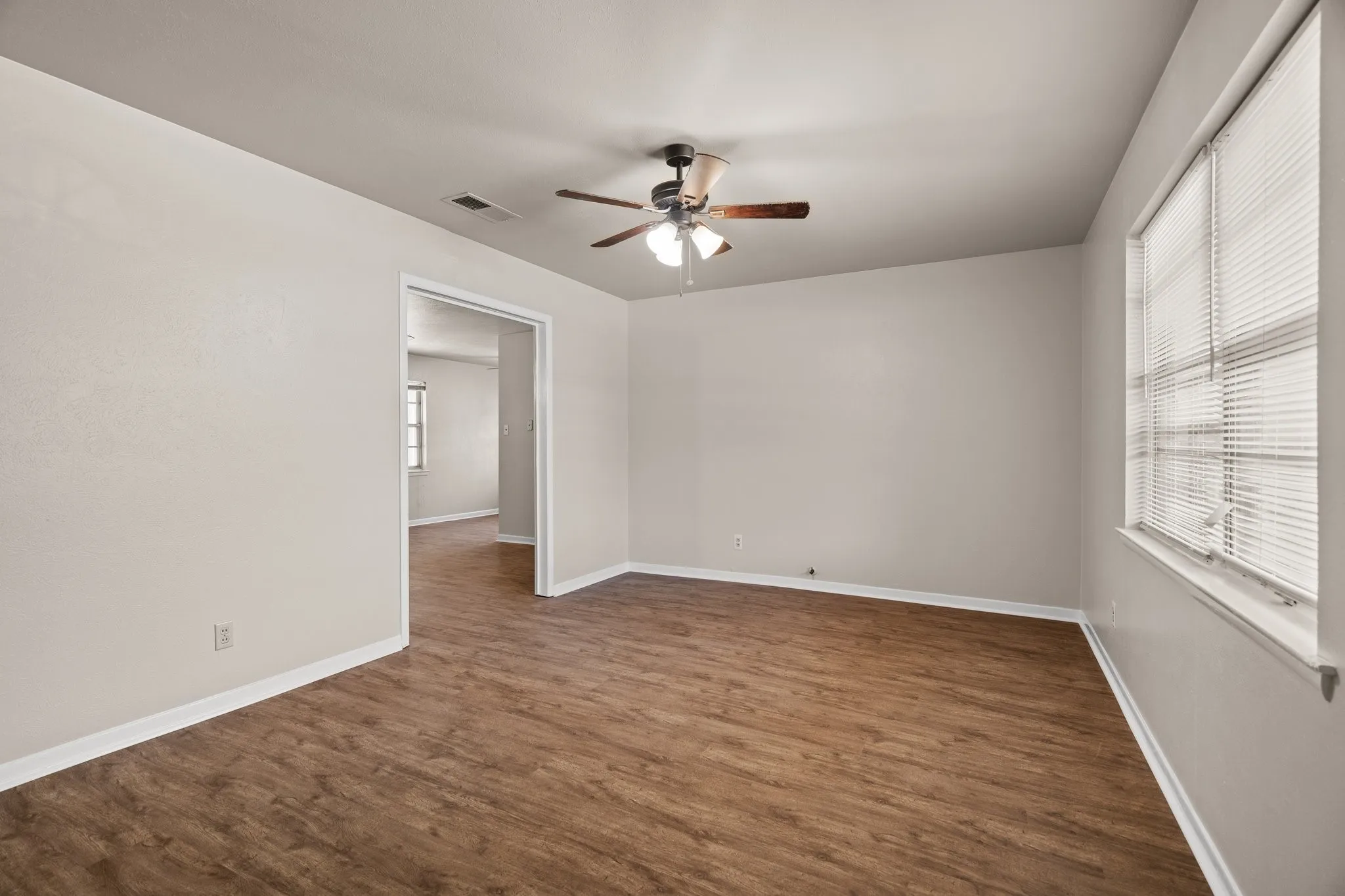 Spare room with ceiling fan and dark hardwood / wood-style flooring