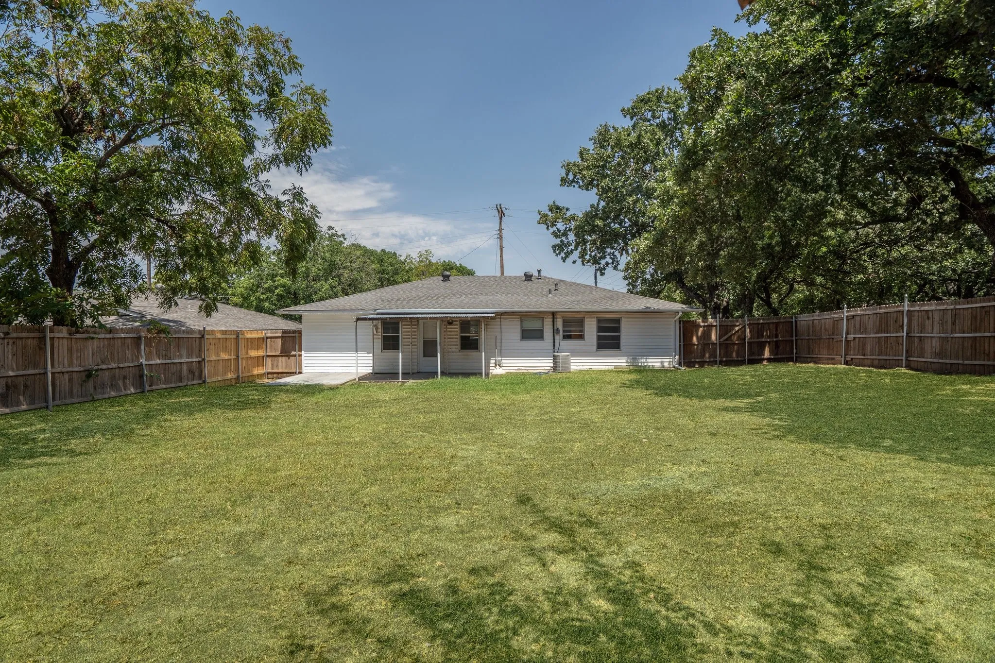Back of property with a lawn
