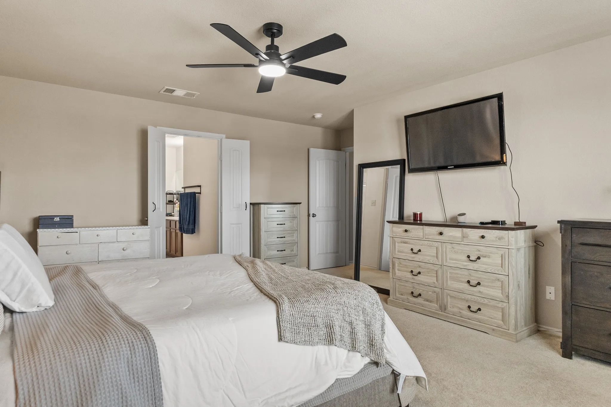 Interior room featuring a ceiling fan with integrated lighting, neutral wall paint, and carpet flooring