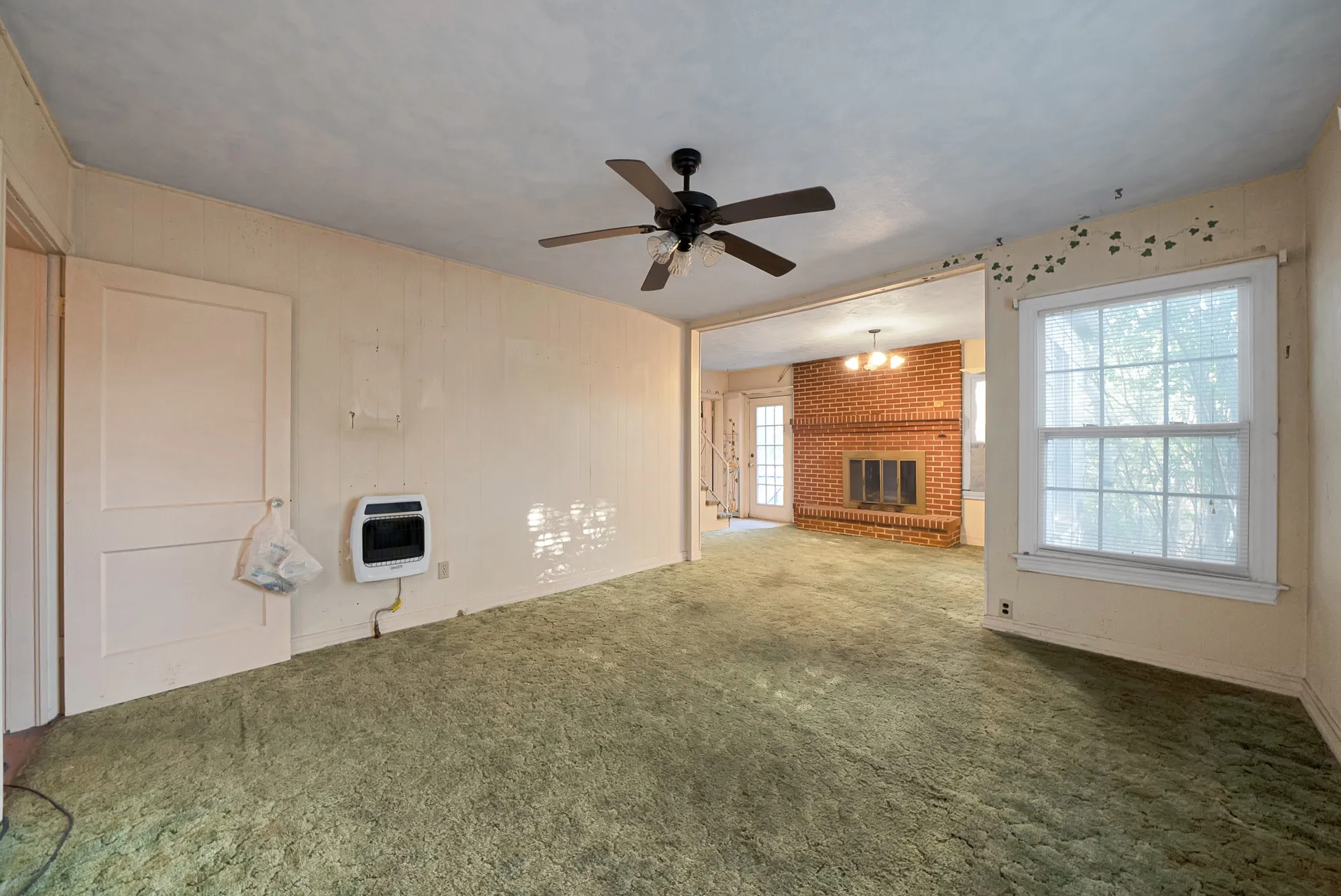 Ceiling fan light fixture and a brick fireplace
