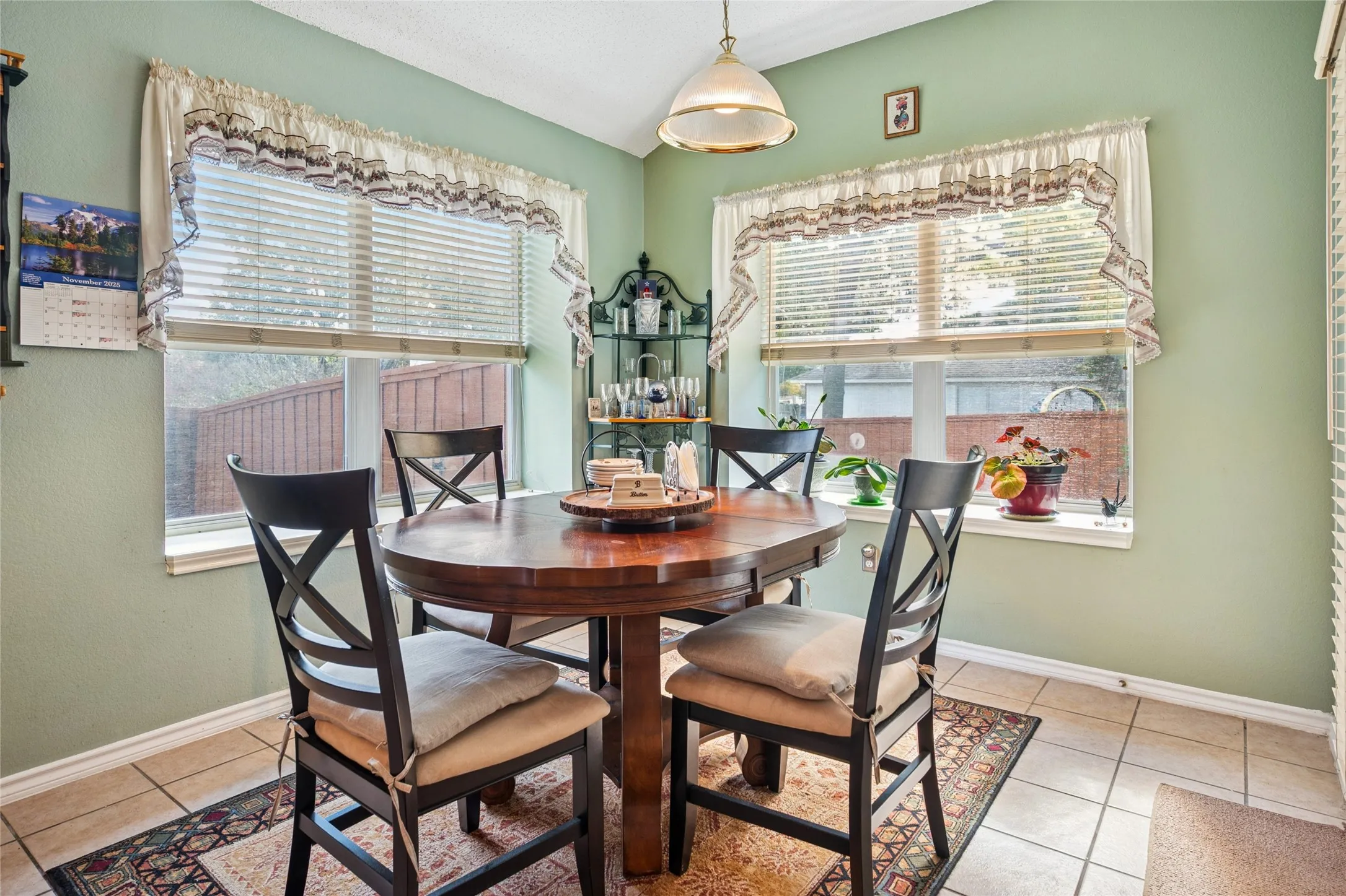 Tile flooring, multiple windows, vaulted ceiling, and recessed lighting
