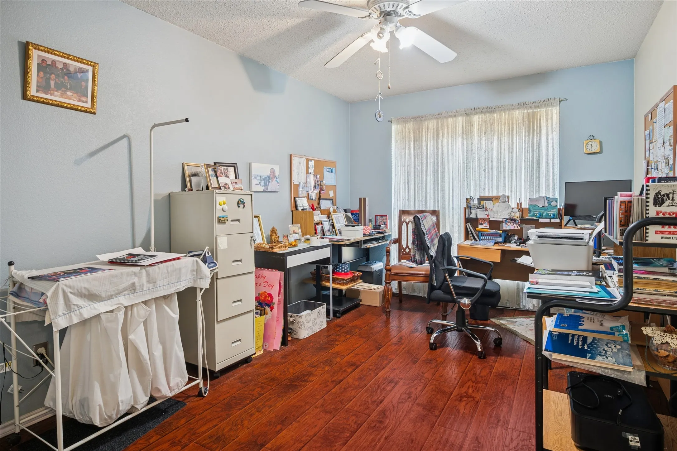Bedroom/Flex space with wood-finish flooring, ceiling fan