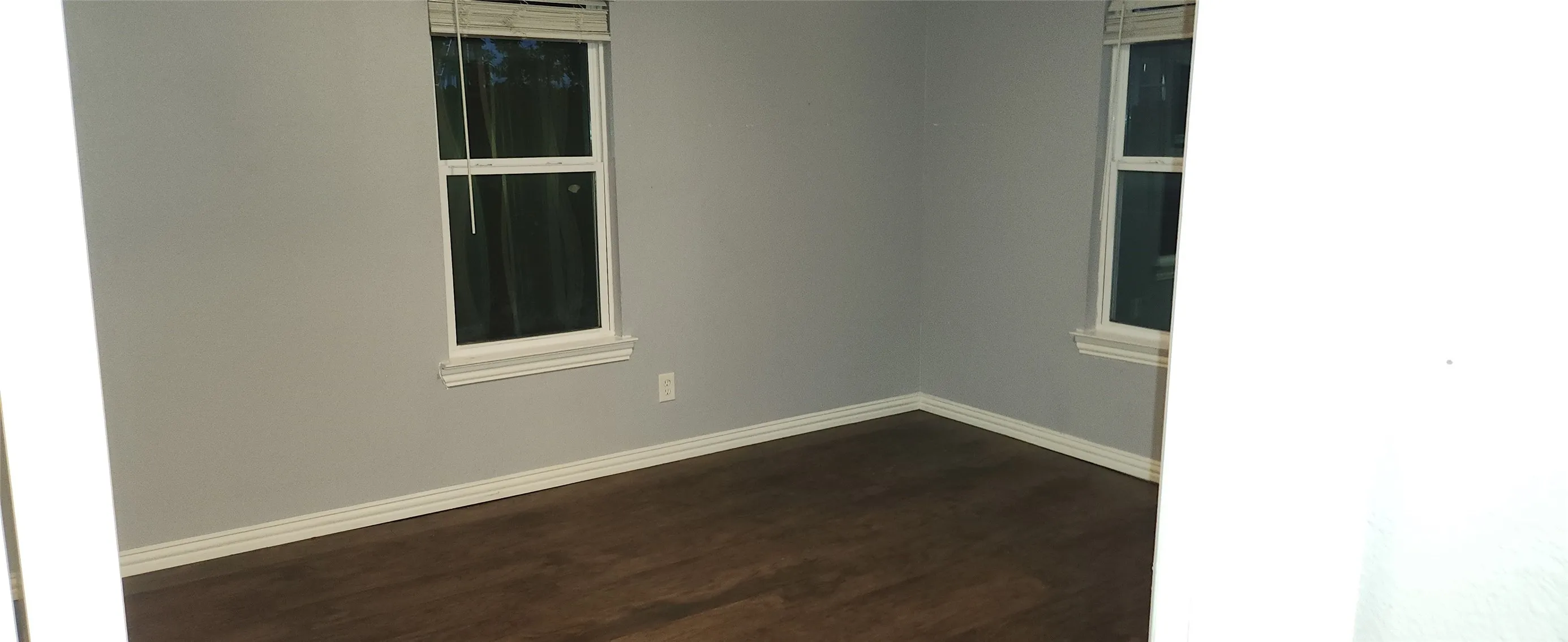 Wood-finish flooring with light gray walls and white trim
