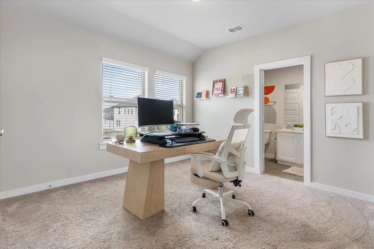 Warm neutral-toned carpeting extends throughout the space, complemented by light-colored walls