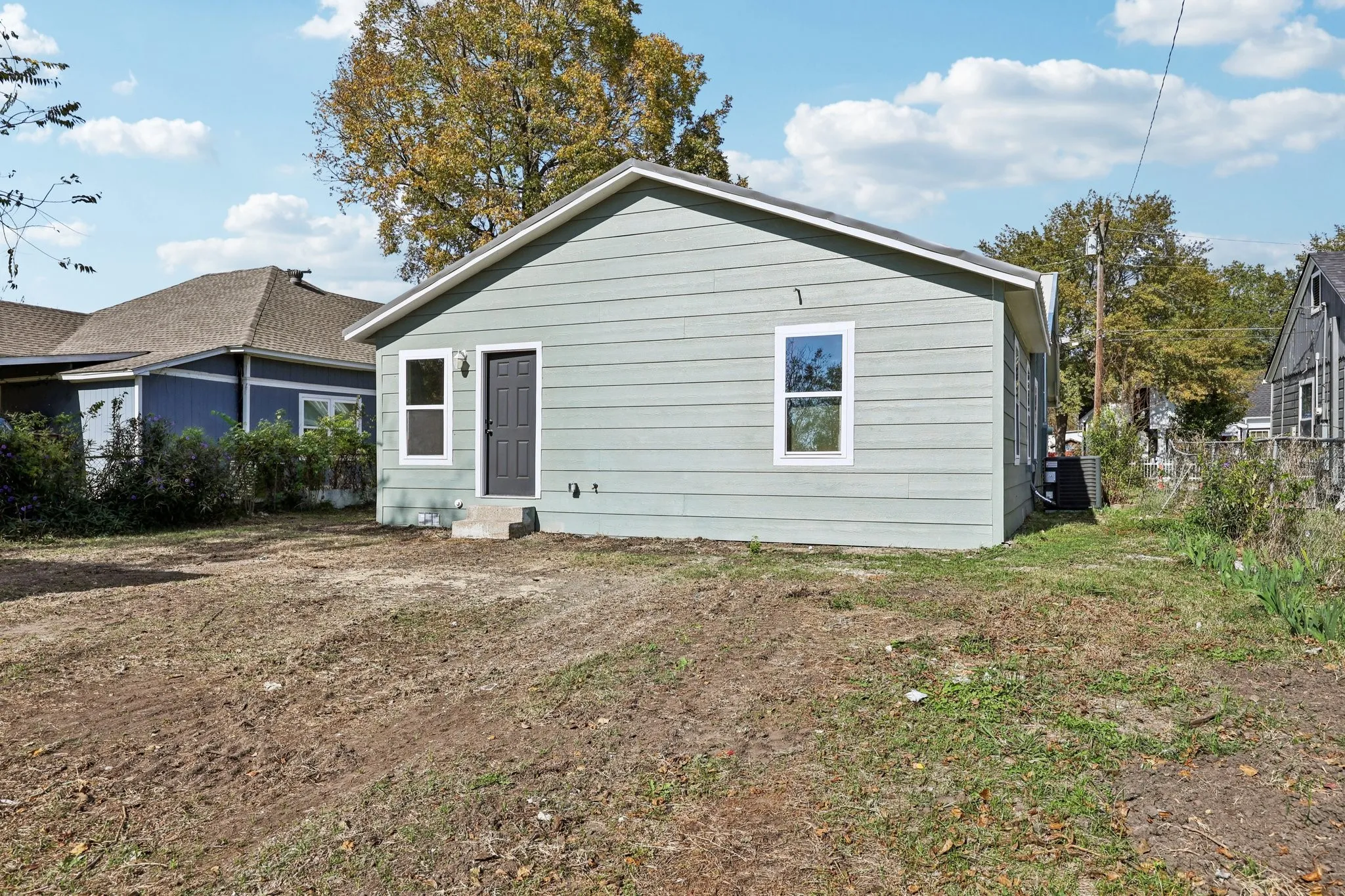 Single-story residence featuring light green horizontal siding and white trim