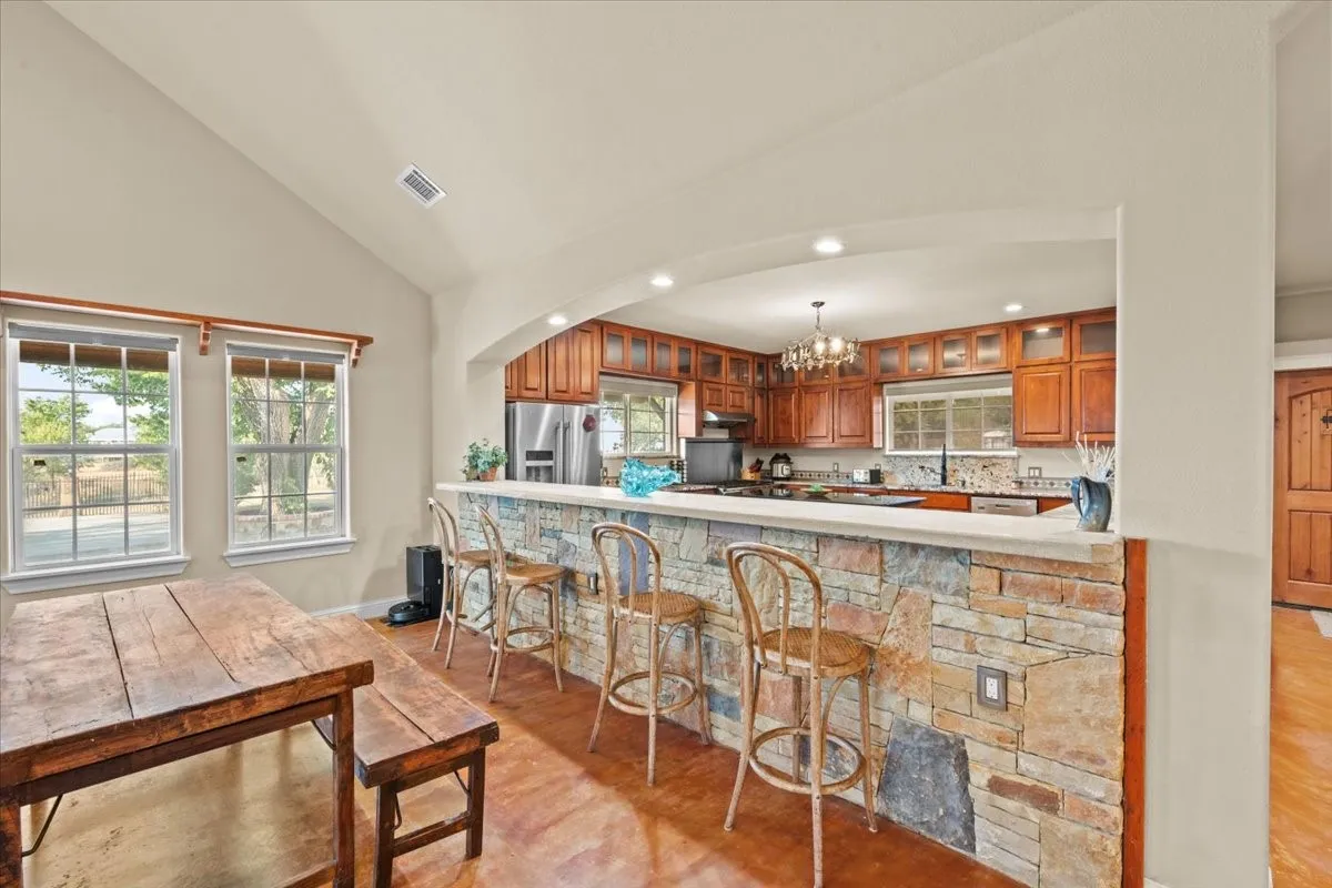 View into the kitchen from dining area at 3601 Oak Cir, Weatherford, TX 76088 - 3664 sq ft on 2.92 acres with a 2600 sq ft workshop