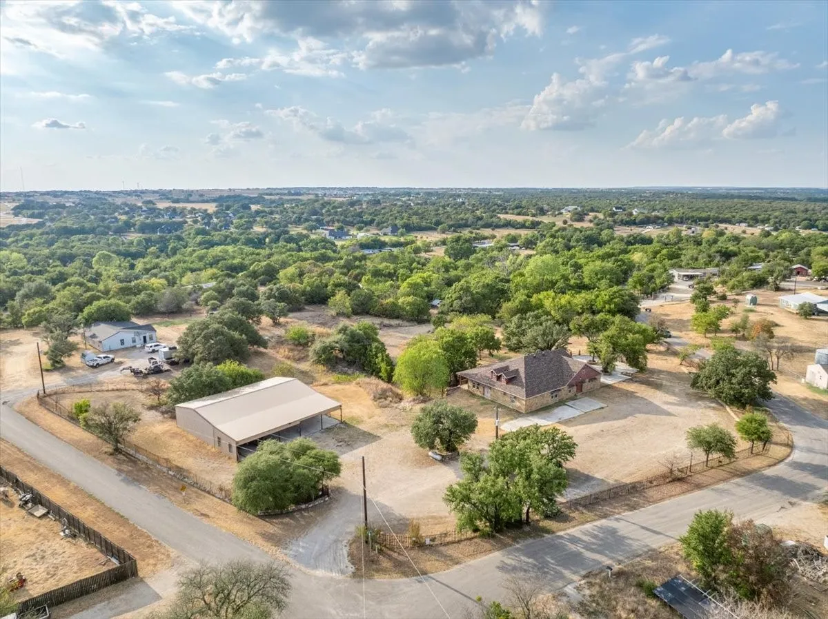 Southeastern aerial view of 3601 Oak Cir, Weatherford, TX -76088; 3664 sq ft on 2.92 acres with a 2600 sq ft workshop