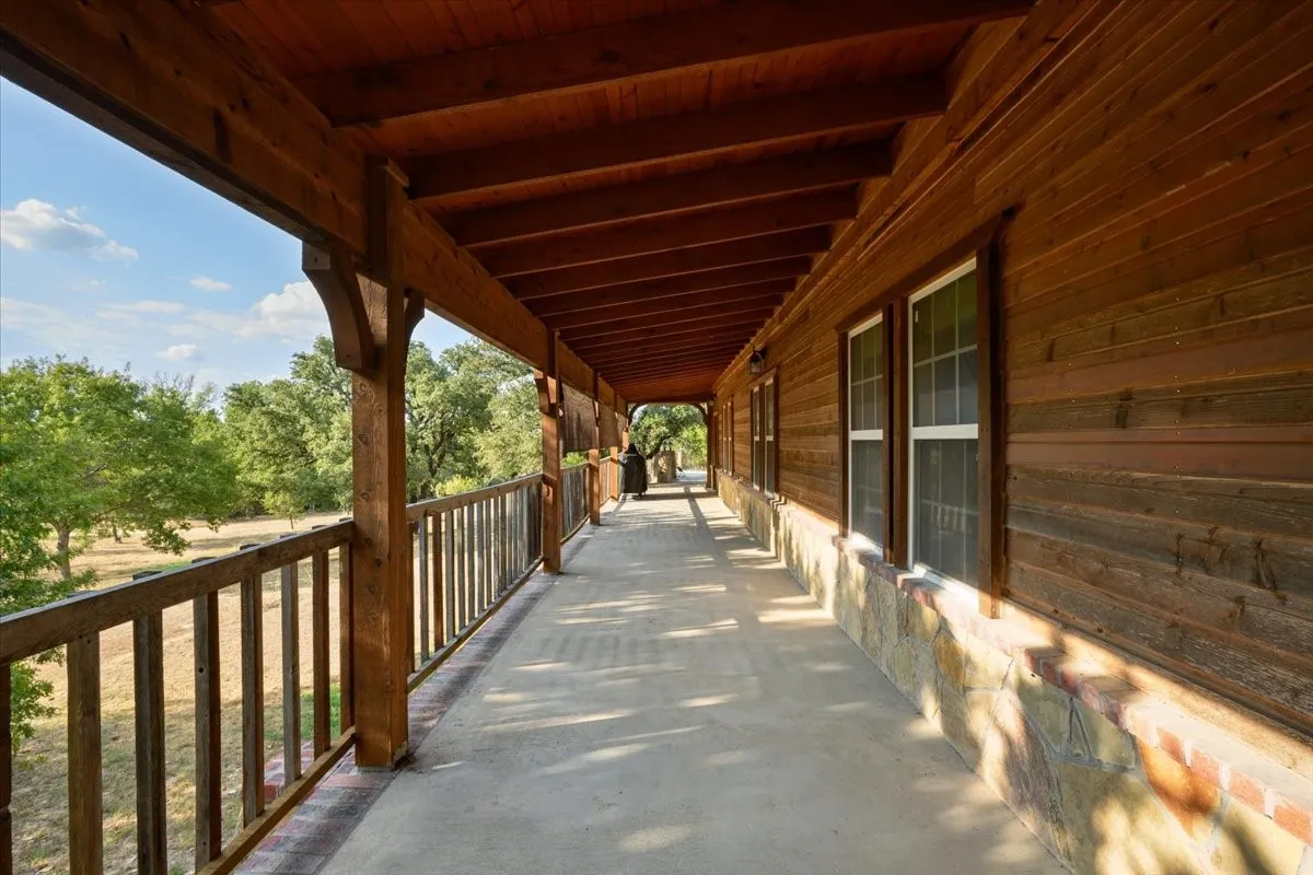 Large balcony overlooking the western side of 3601 Oak Cir, Weatherford, TX 76088 - 3664 sq ft on 2.92 acres with a 2600 sq ft workshop