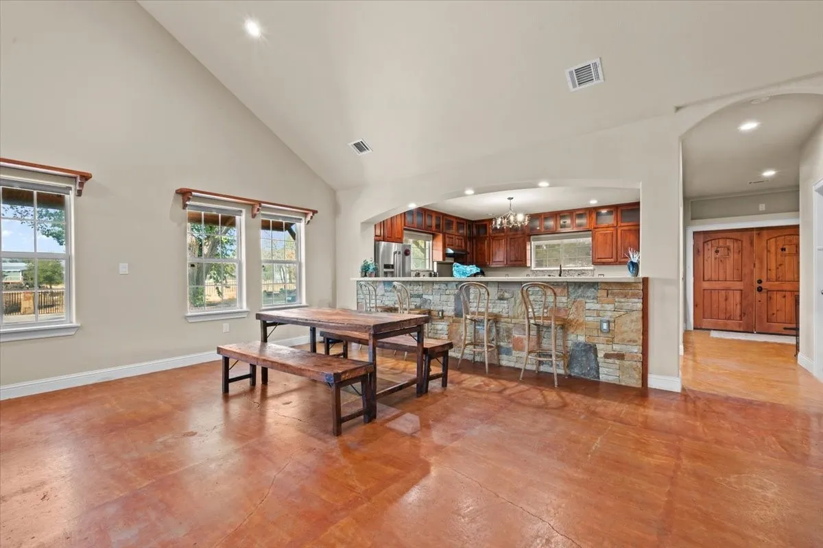 View of dining area, kitchen and front door at 3601 Oak Cir, Weatherford, TX 76088 - 3664 sq ft on 2.92 acres with a 2600 sq ft workshop
