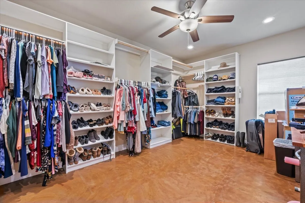 Spacious primary closet with ceiling fan at 3601 Oak Cir, Weatherford, TX 76088 - 3664 sq ft on 2.92 acres with a 2600 sq ft workshop