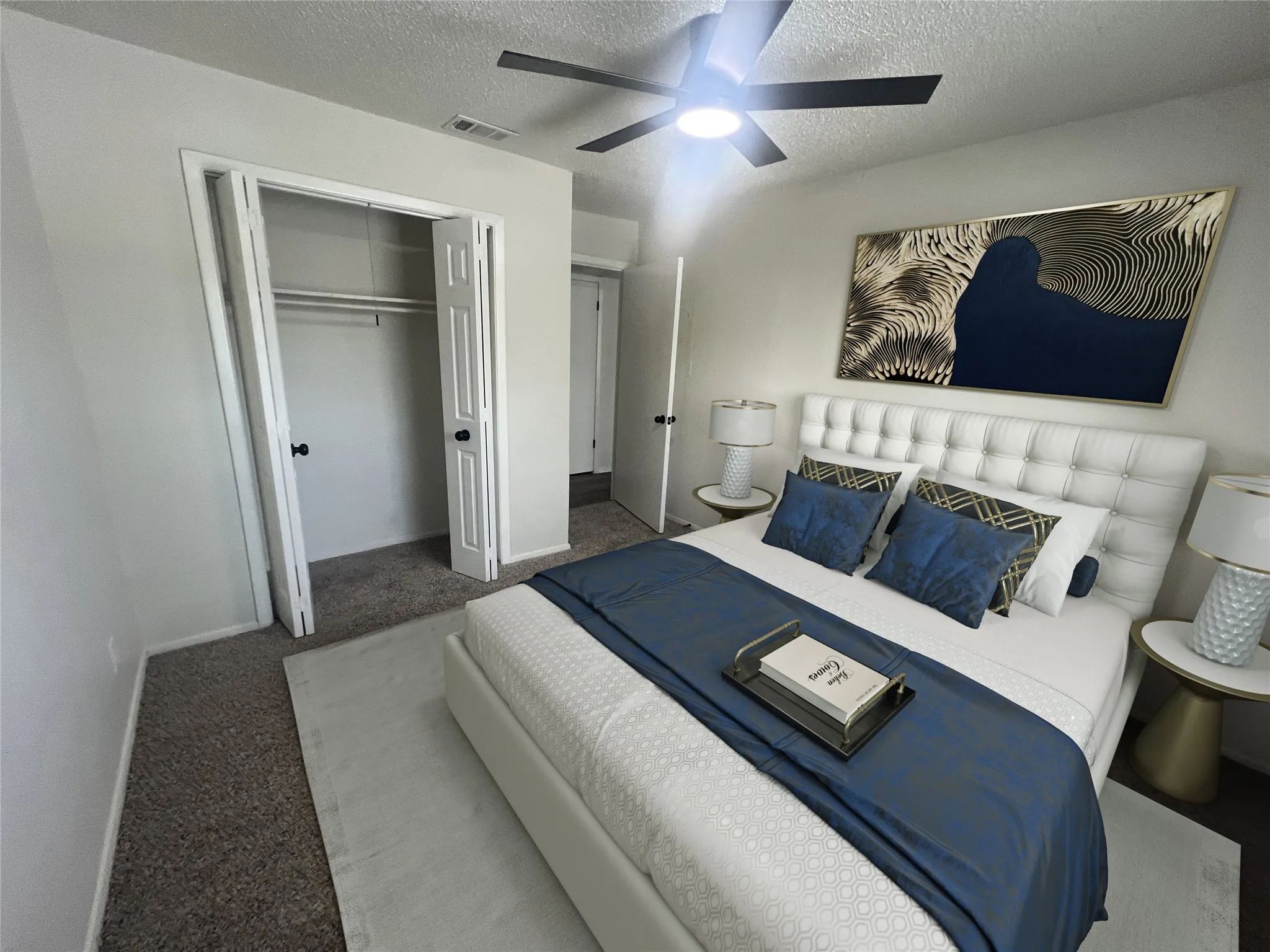 Carpeted bedroom with a textured ceiling, a closet, and a ceiling fan