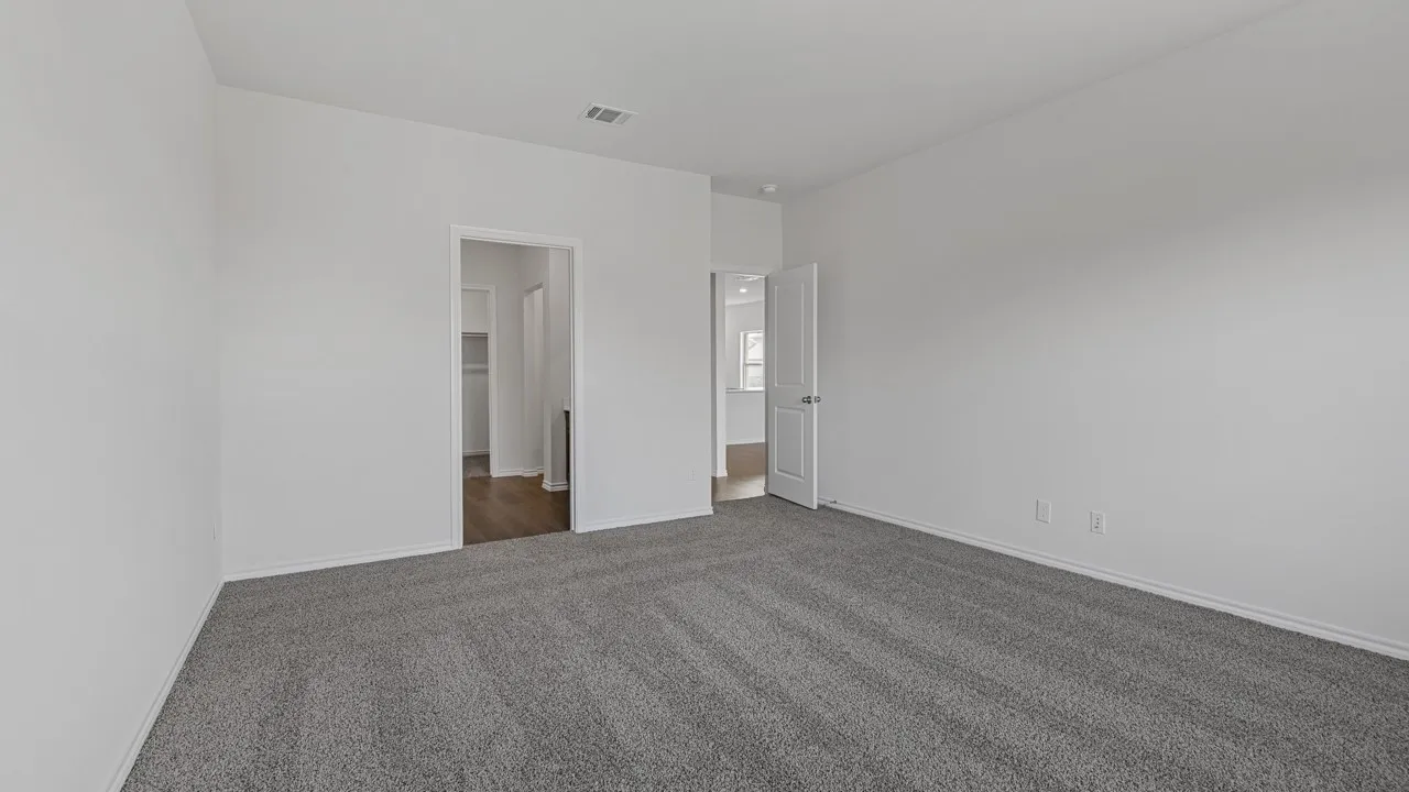 Spacious room featuring gray carpeting, white painted walls, and white trim