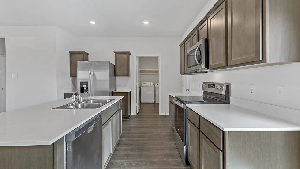 Kitchen featuring wood-finish flooring, recessed lighting, and stainless steel appliances