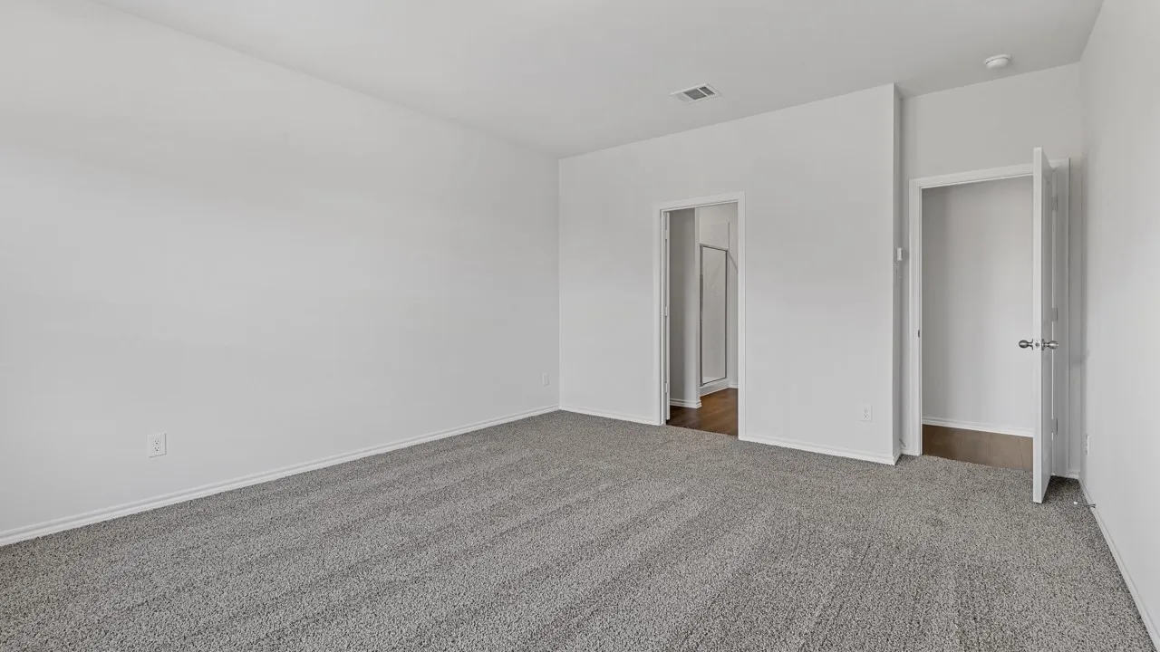 Neutral wall paint, gray carpet flooring, recessed ceiling lighting, and two interior doorways
