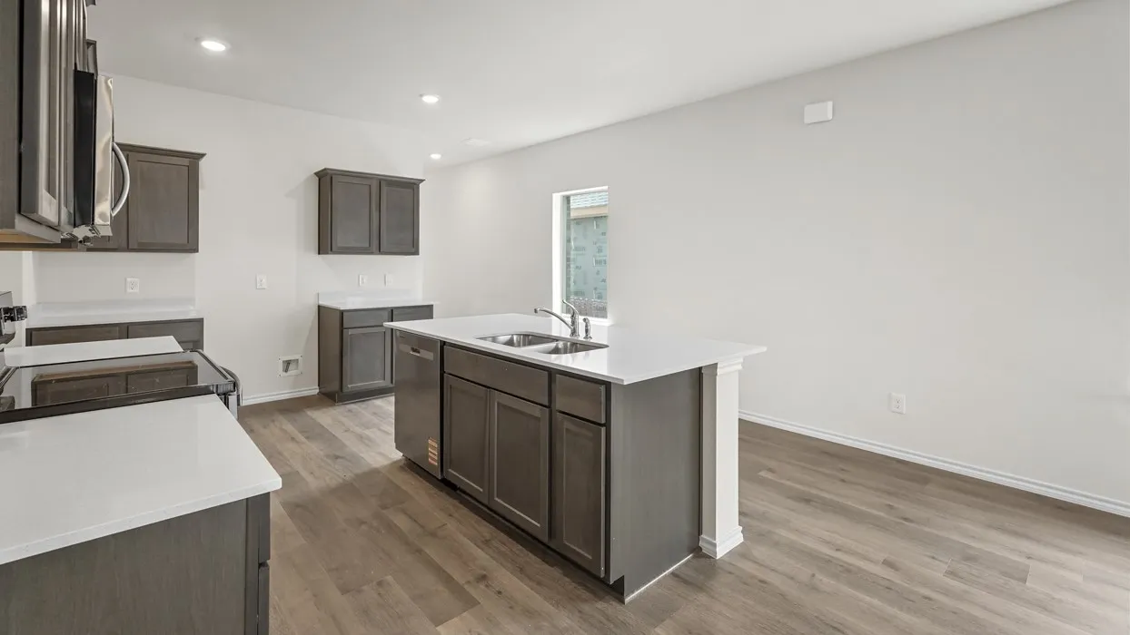 Kitchen featuring an island with dual sinks, white countertops, dark wood-finish cabinetry, and wood-finish flooring