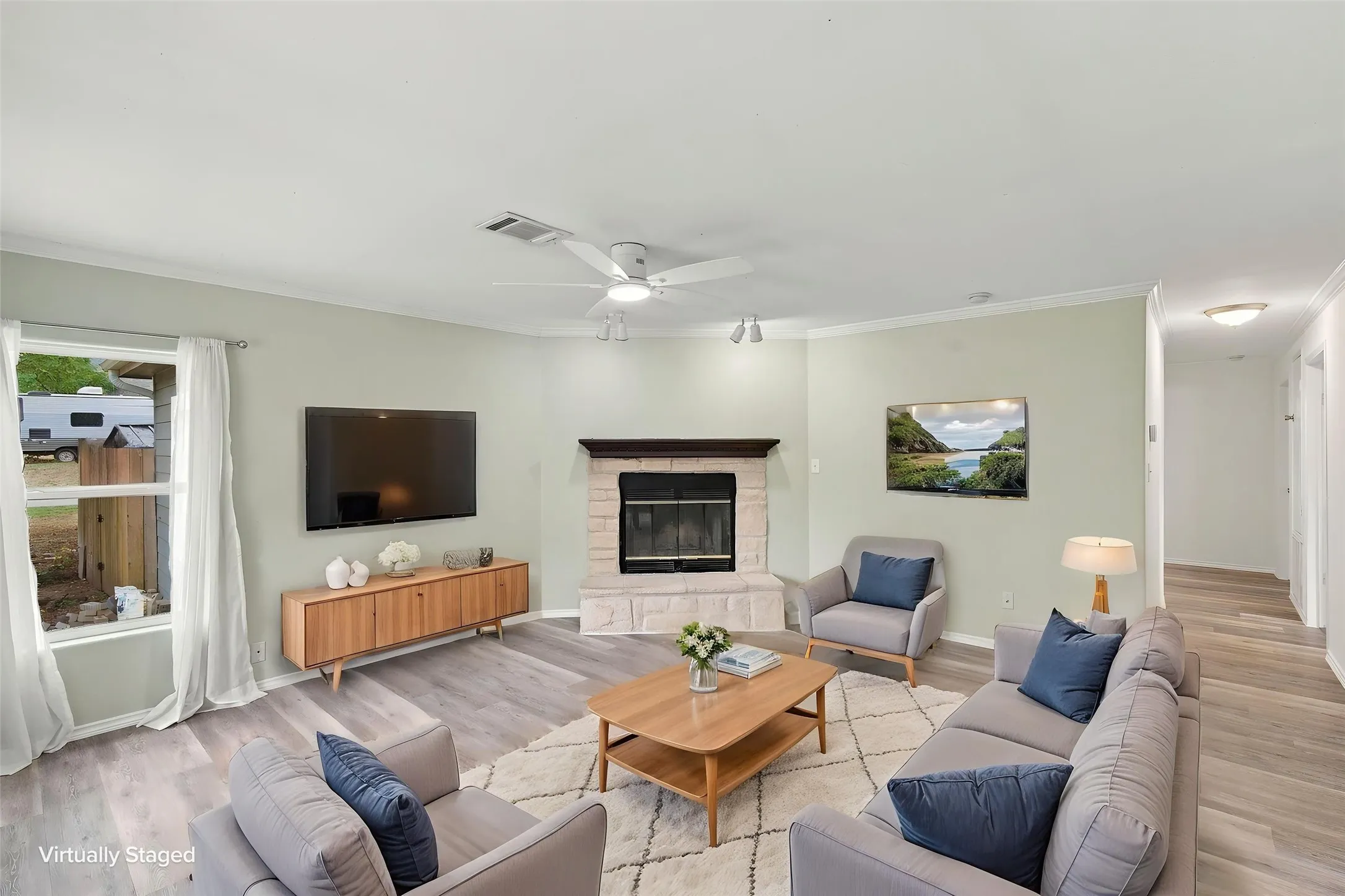 Virtually staged. Corner fireplace with a stone surround, wood-finish mantel, and built-in hearth