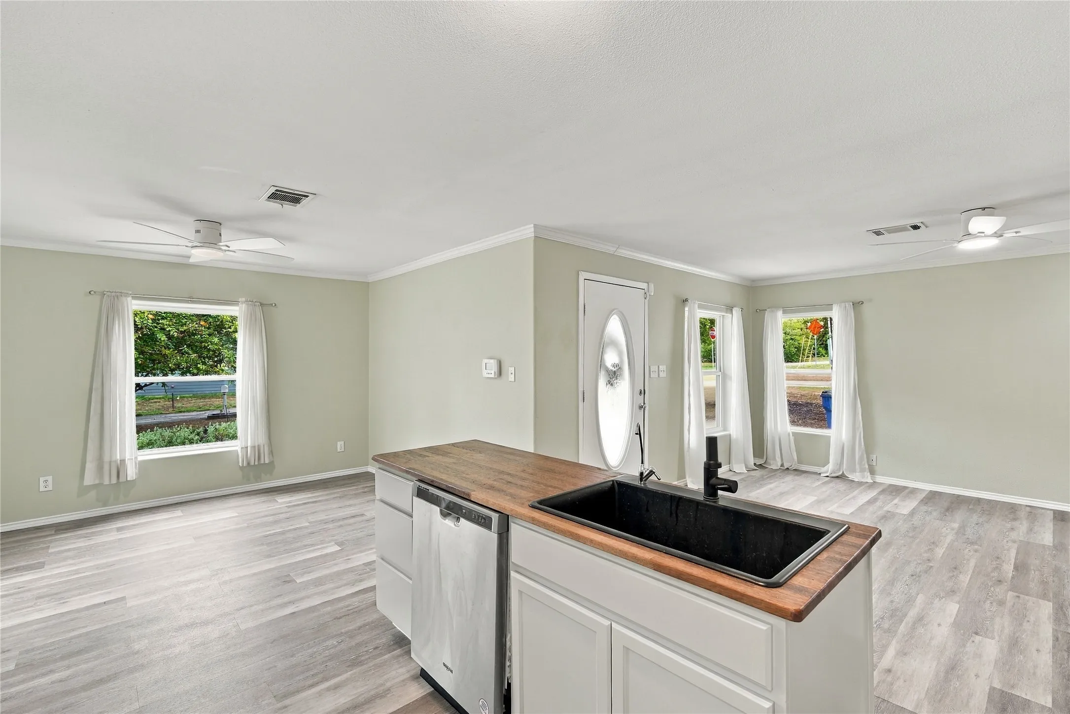 Wood-look flooring, open concept  and crown molding