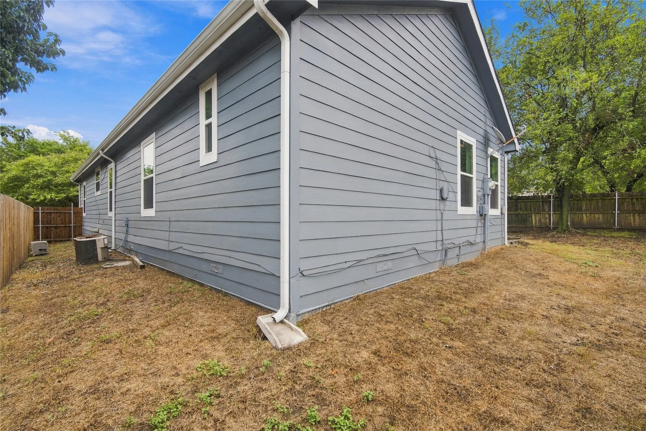 Exterior with white window trim and white gutters