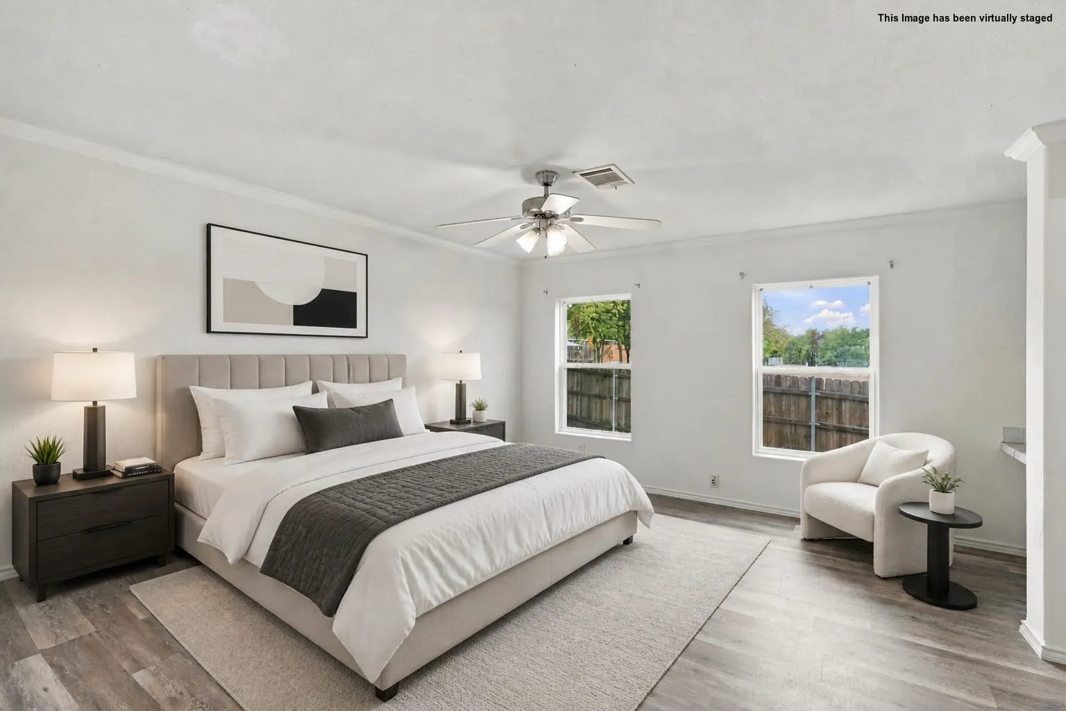 Virtually Staged. Wood-look flooring, crown molding, and a ceiling fan with integrated lighting