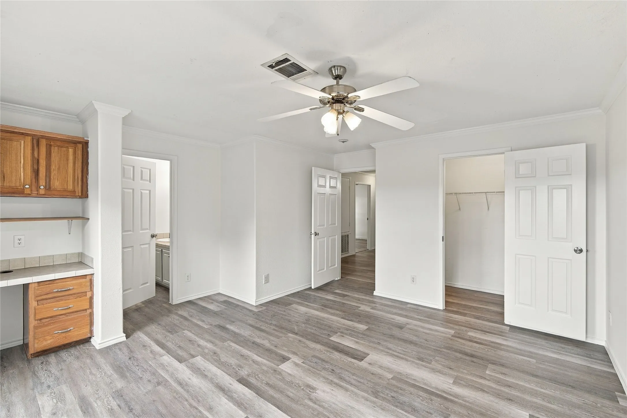 Built in cabinets and desk. Walk in closet