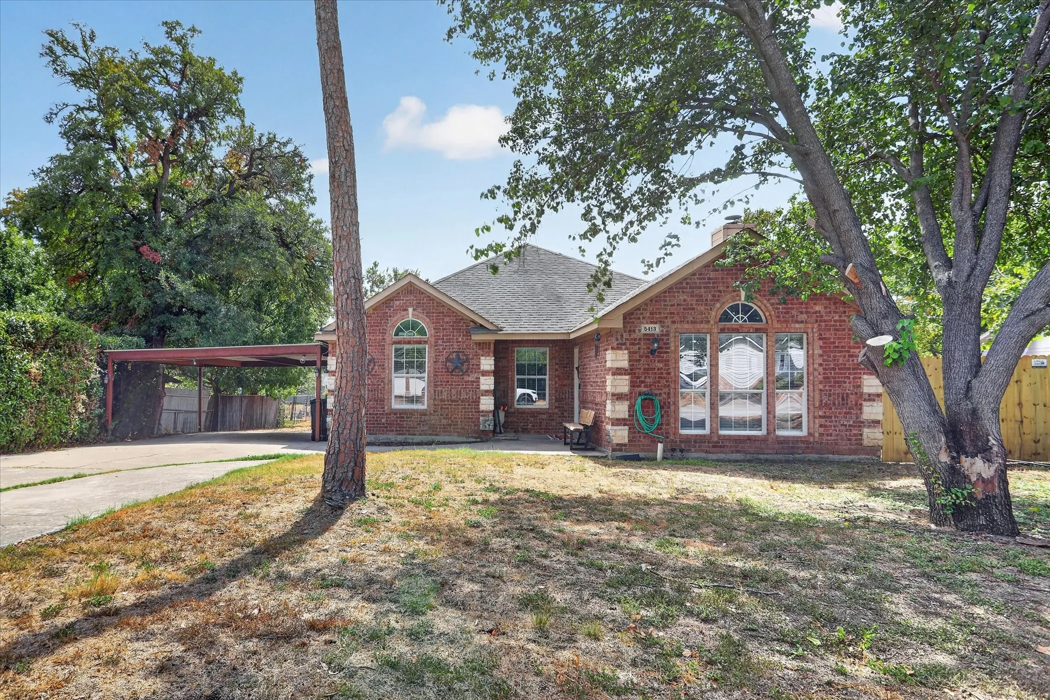Brick exterior with a gabled roof and arched window accents