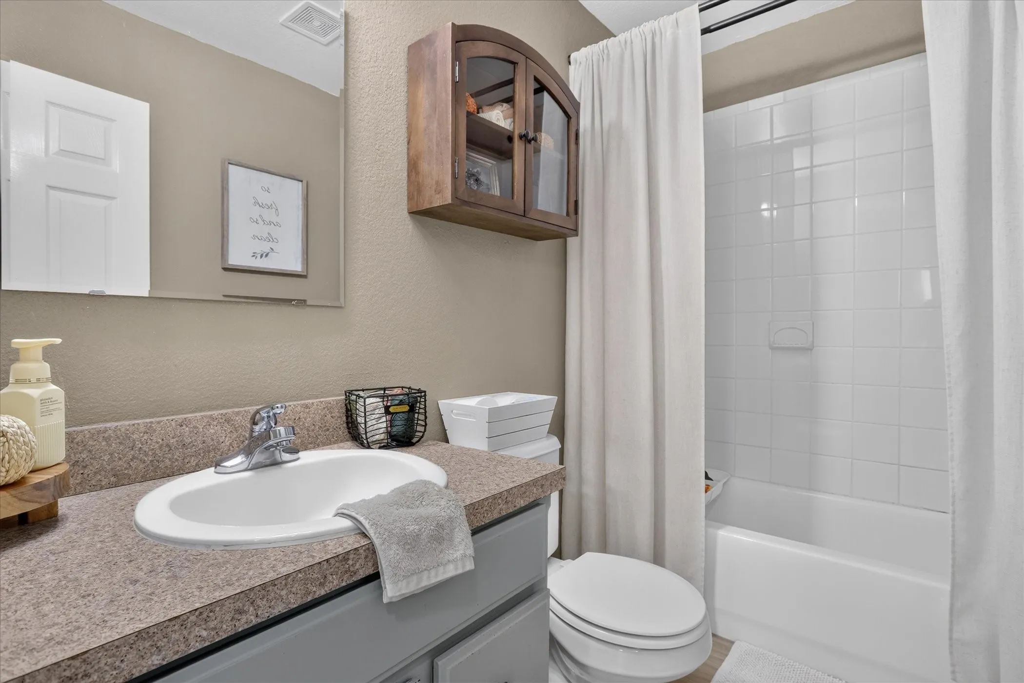White subway tile bath/shower combination with a built-in soap dish