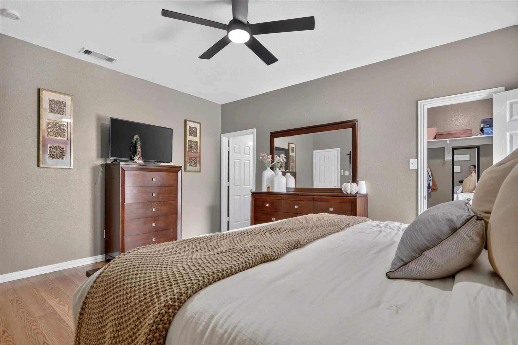 Wood-finish flooring with neutral wall tones and white trim