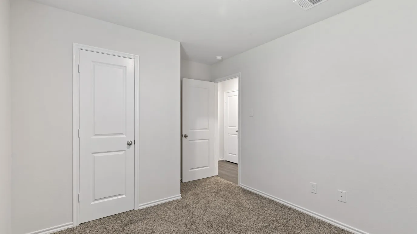 Neutral wall paint, white trim, paneled interior doors, and carpet flooring