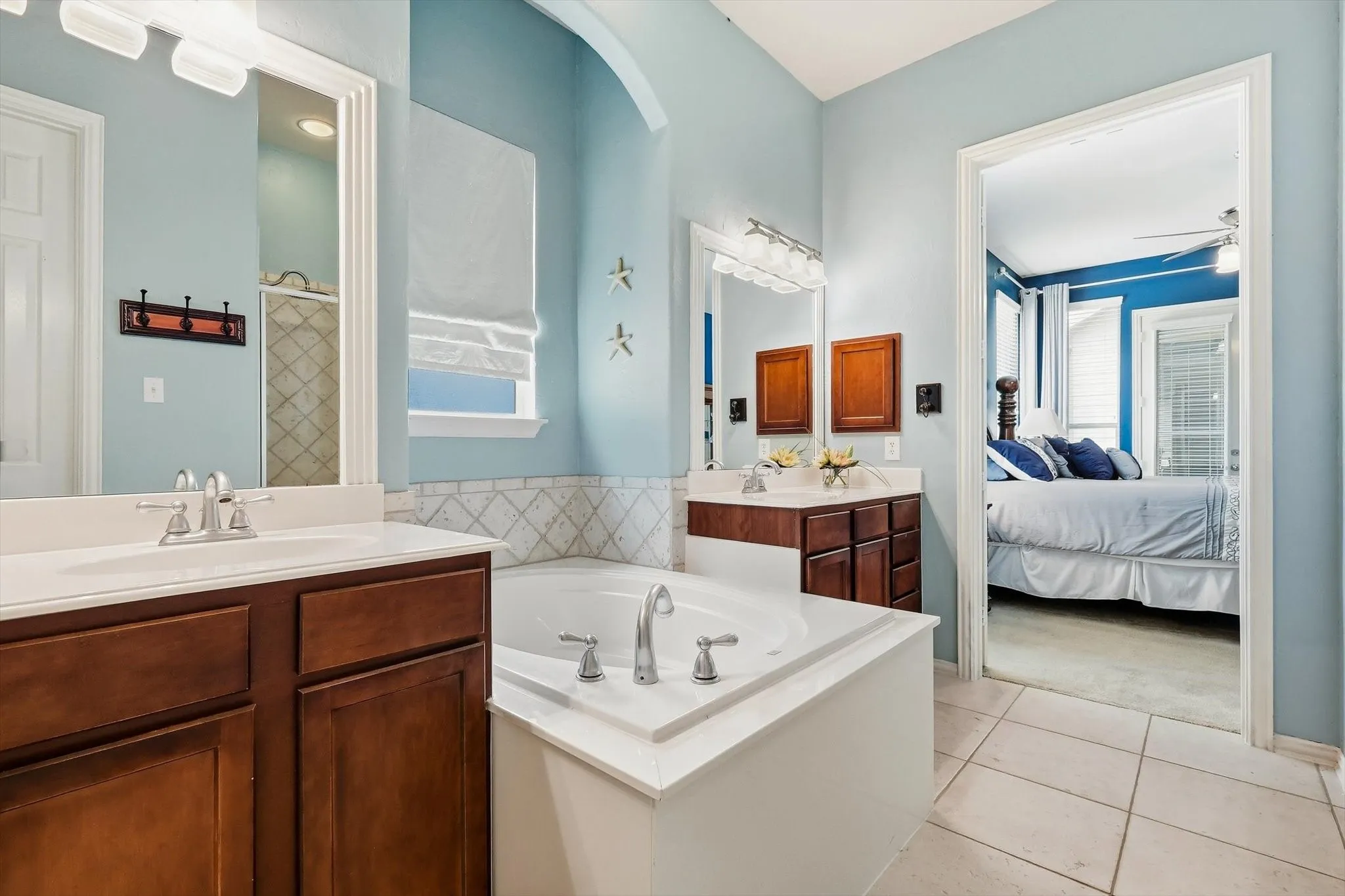 Enjoy a soothing soak or a refreshing shower in a primary bathroom designed with both options.