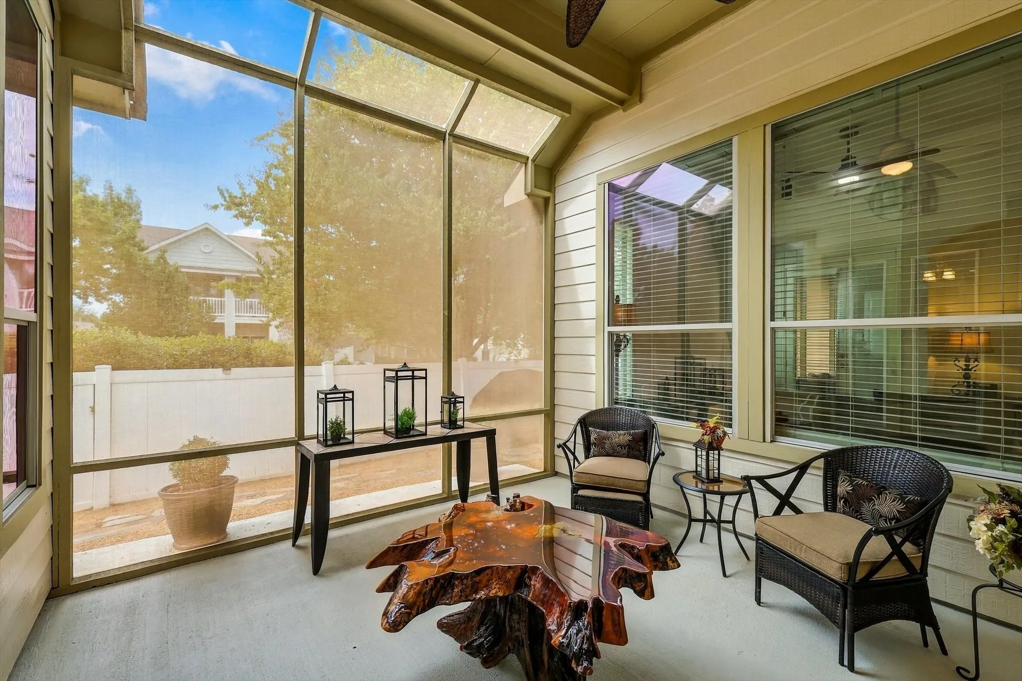 Start your morning with coffee on the screened side patio, surrounded by light and outdoor views.