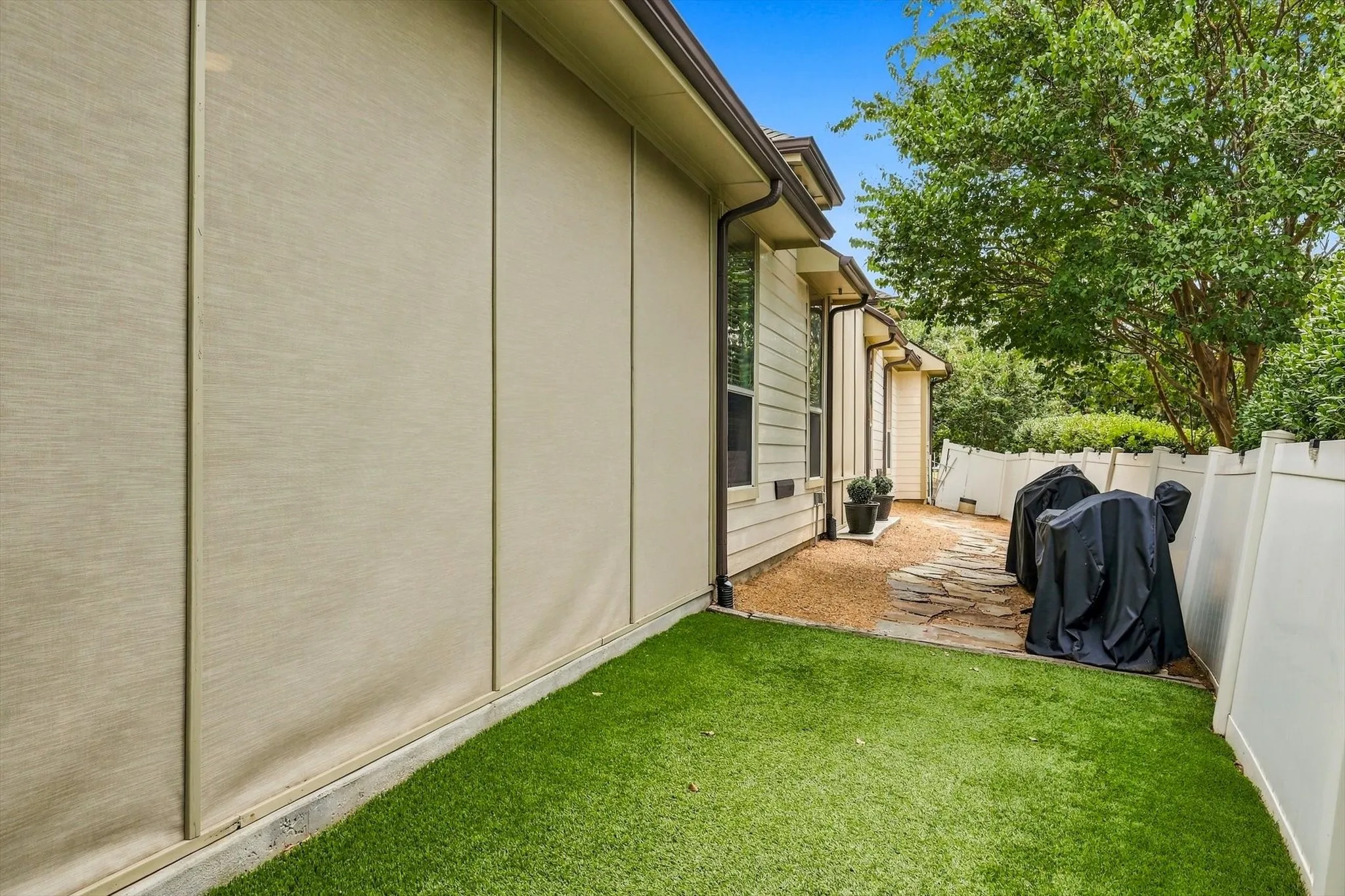 Turf alongside the screened patio adds another easy-care outdoor space to enjoy.