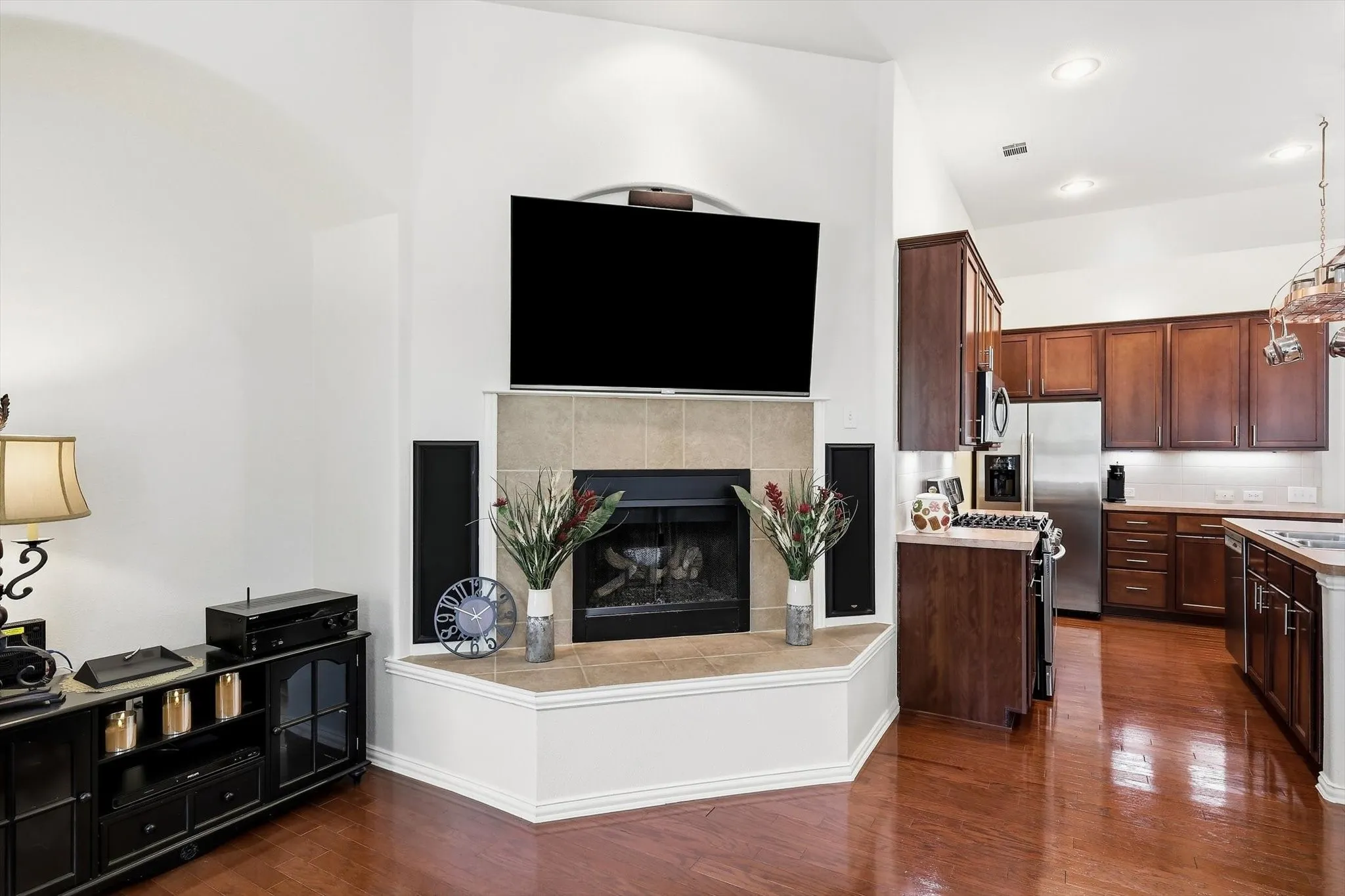A corner gas fireplace adds warmth and character, with built-in speakers enhancing the family room experience.