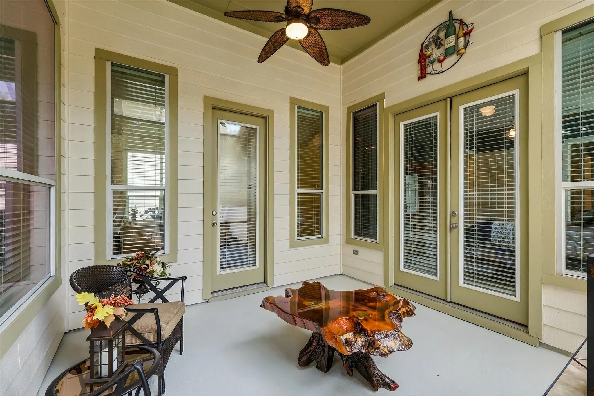 With a ceiling fan and convenient interior access, the screened side patio feels like an extension of the home.