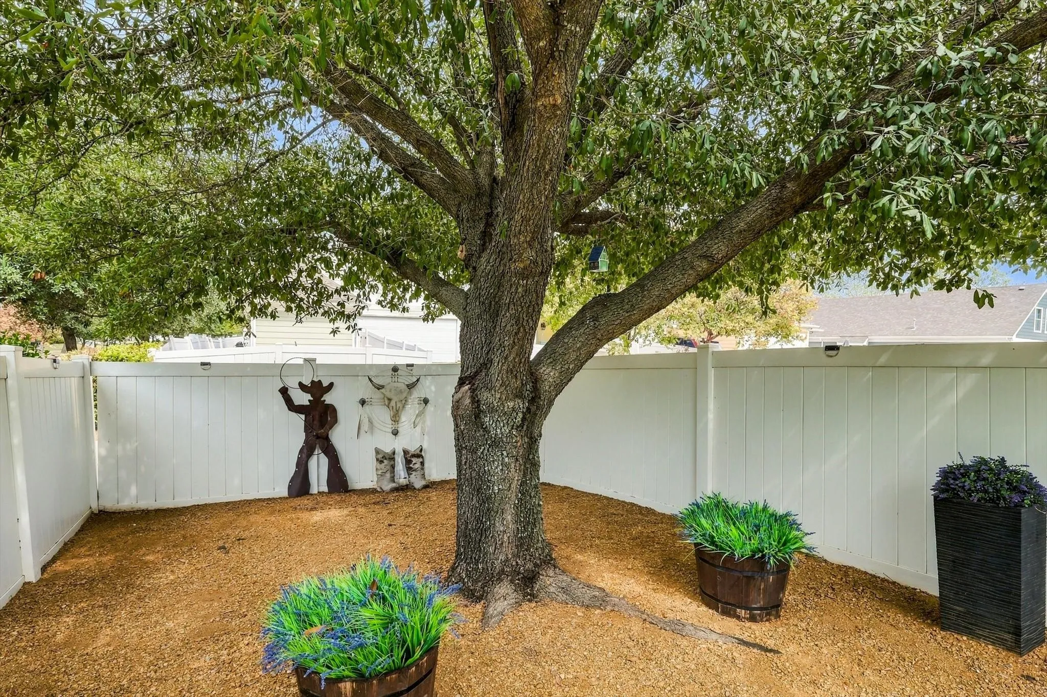 Mature shade and professionally installed crushed granite create a peaceful backyard corner.