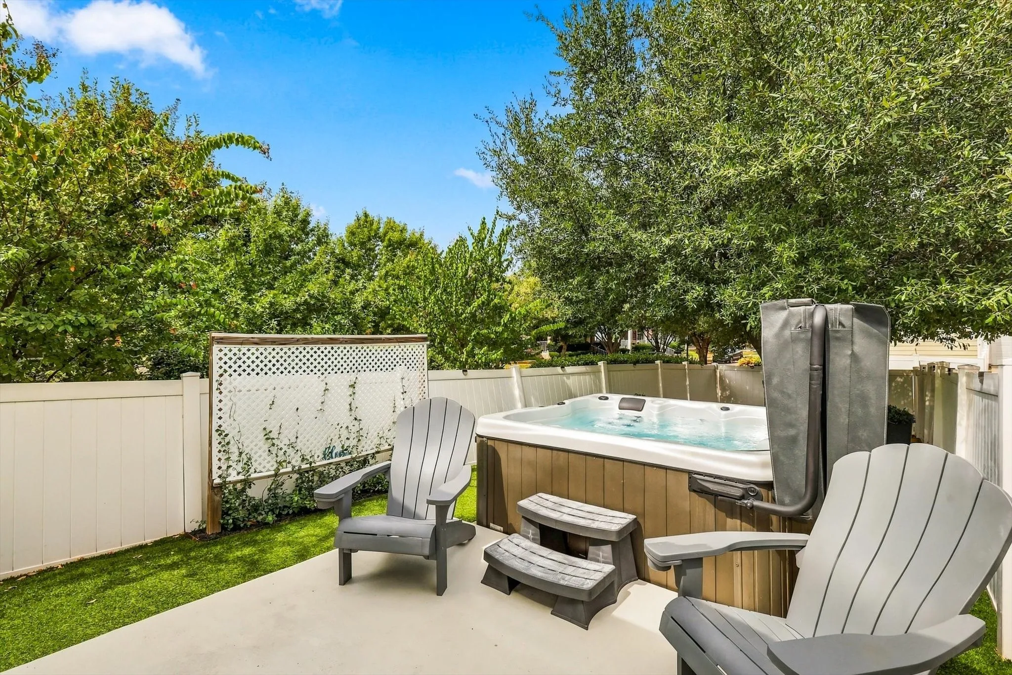 Your own backyard escape—a Cal Spa hot tub and nearby seating invite you to slow down and unwind.