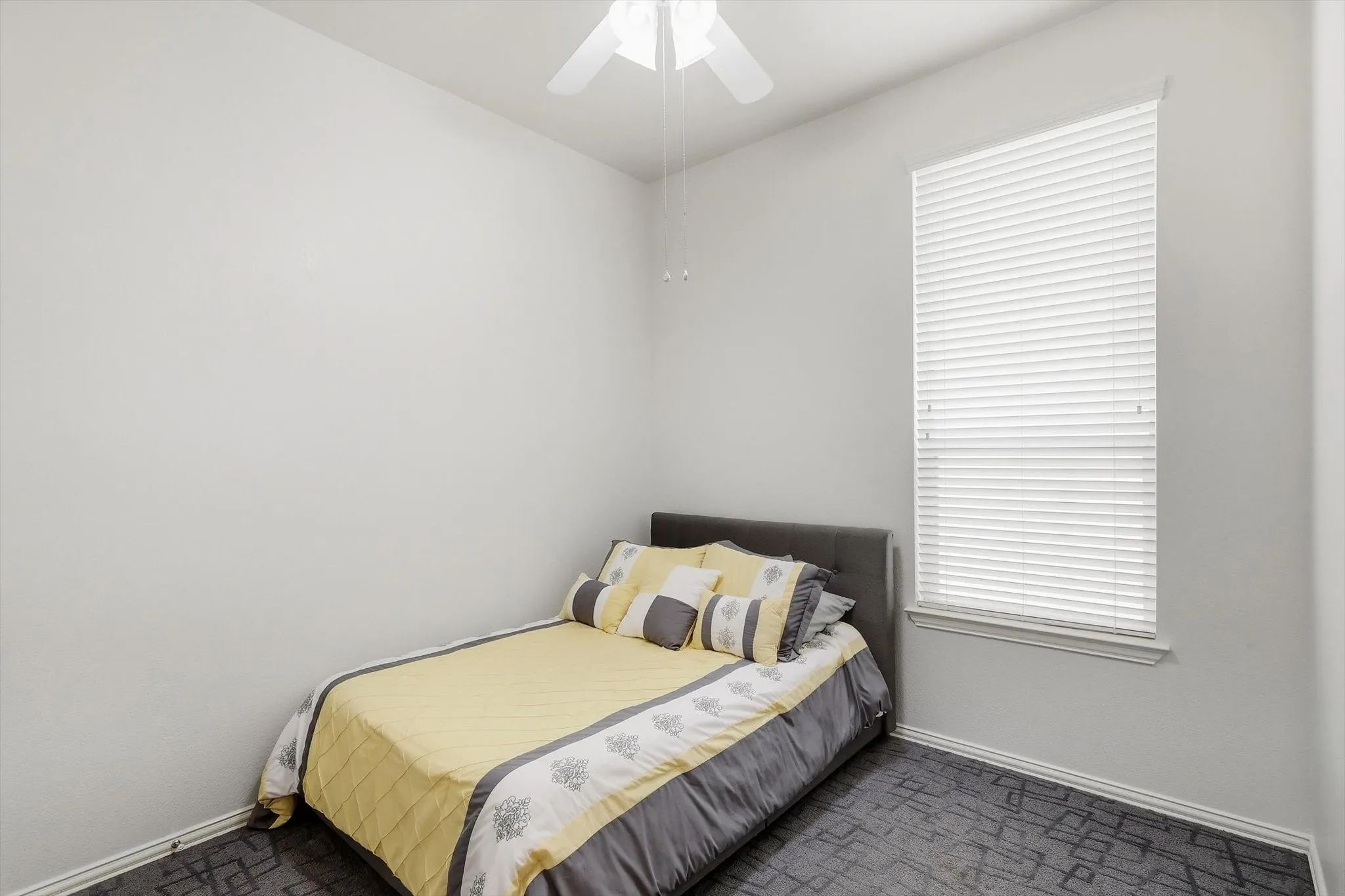 A comfortable secondary bedroom provides space for guests, family, or your own creative use.